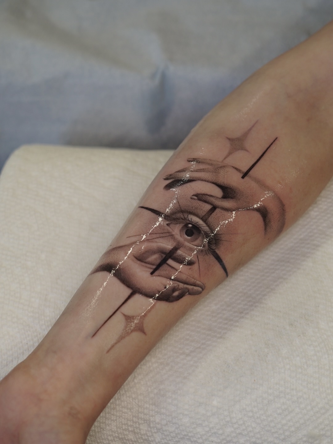 Eye and hand realism tattoo on the forearm by Josh Infante