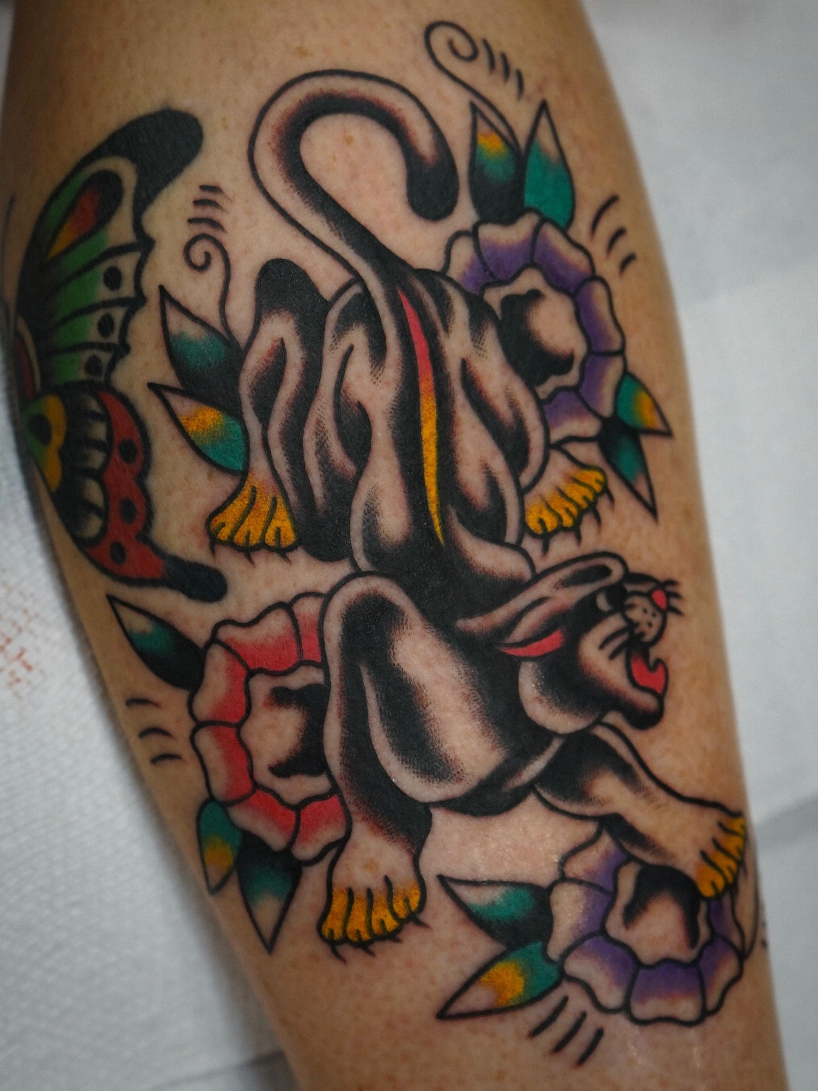 Panther and roses American traditional tattoo on the forearm by Emily Devenz