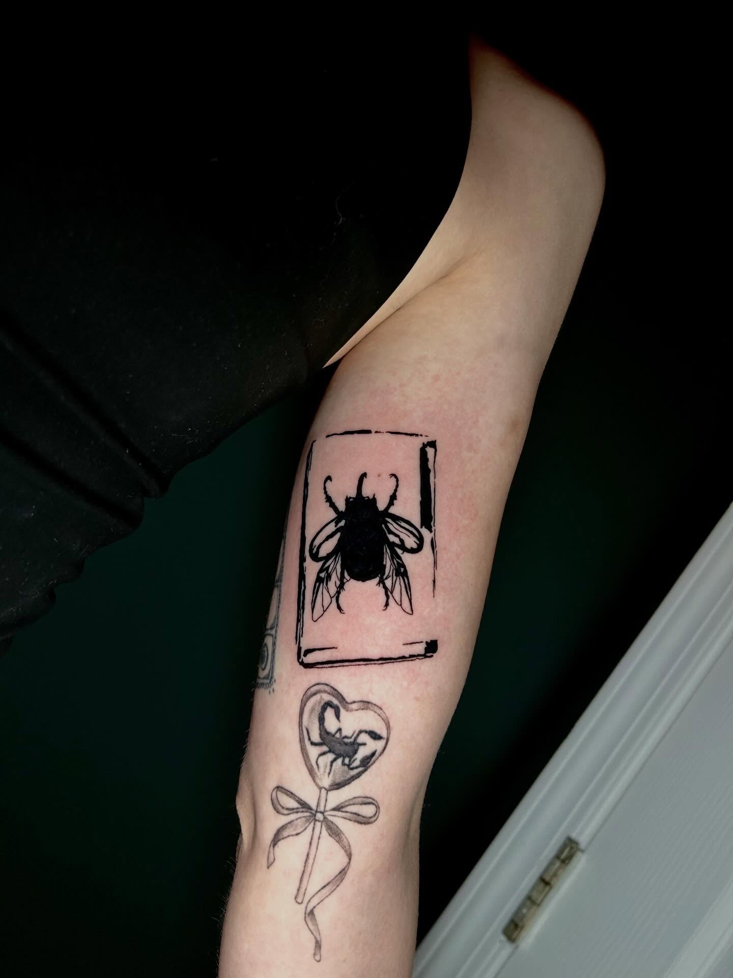 Bee and heart black and grey tattoo on the forearm by KB