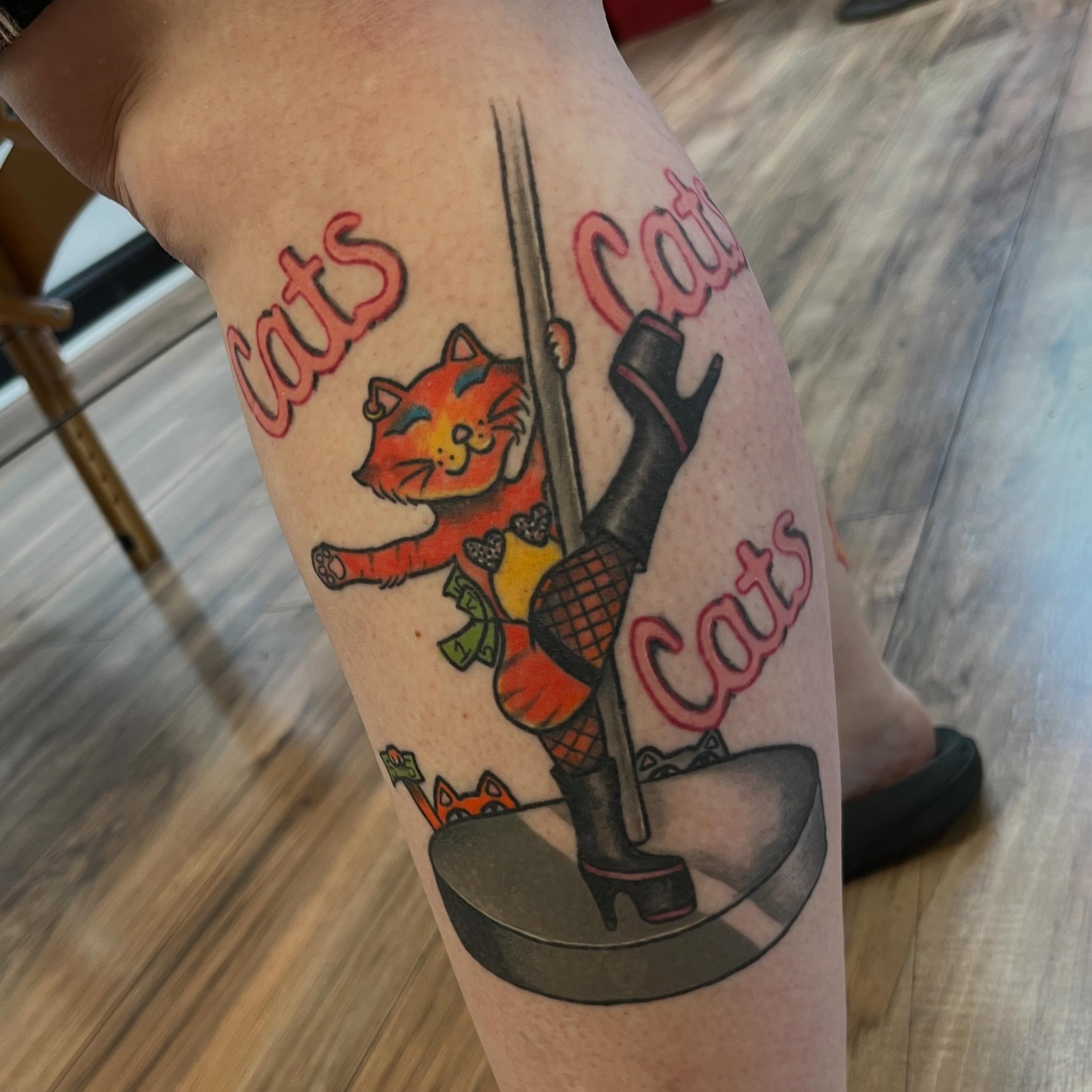 Cat pole dancing American traditional tattoo on the thigh by Danielle Lorandeau