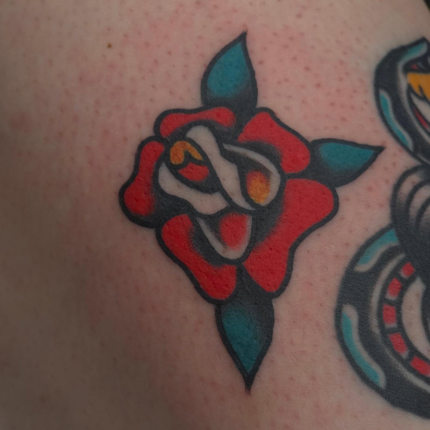 Rose American traditional tattoo on the upper arm by Clayton Harpole, Jefferson, Oregon