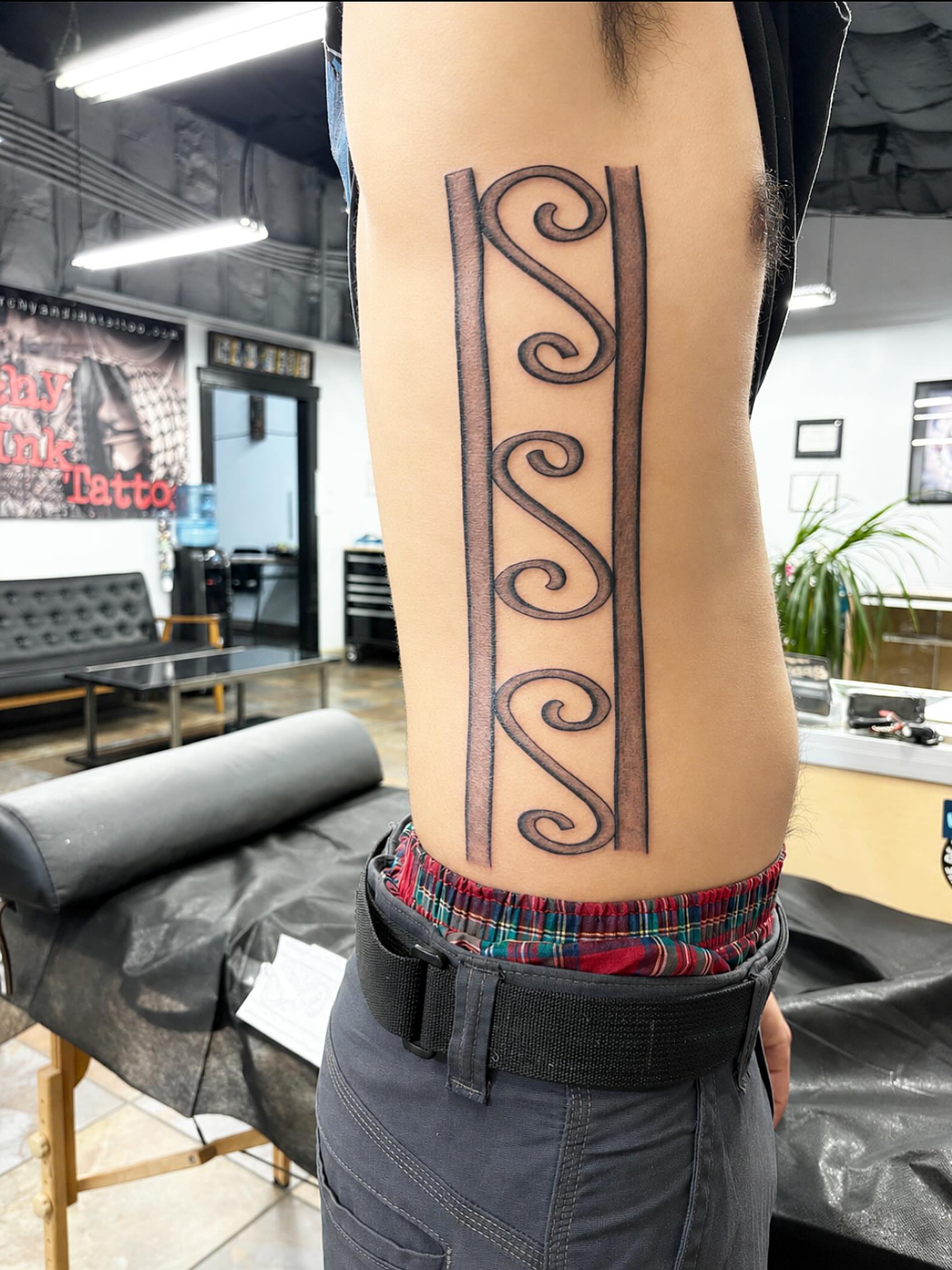 Swirls black and grey tattoo on the thigh by Stoney