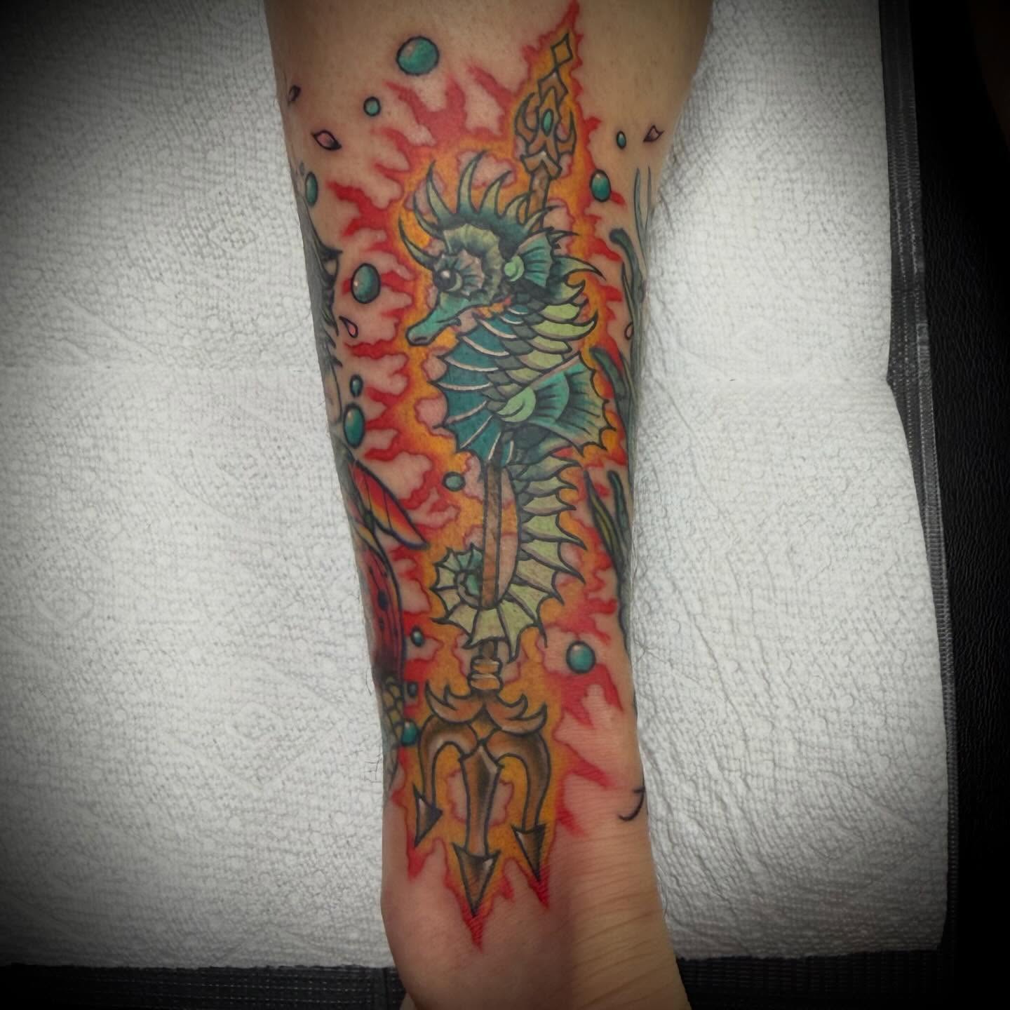 Seahorse and trident American traditional tattoo on the forearm by Mike Lachowicz