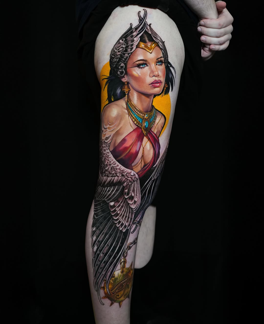 Woman with wings and Egyptian amulet surrealism tattoo on the forearm by Daria Pirojenko