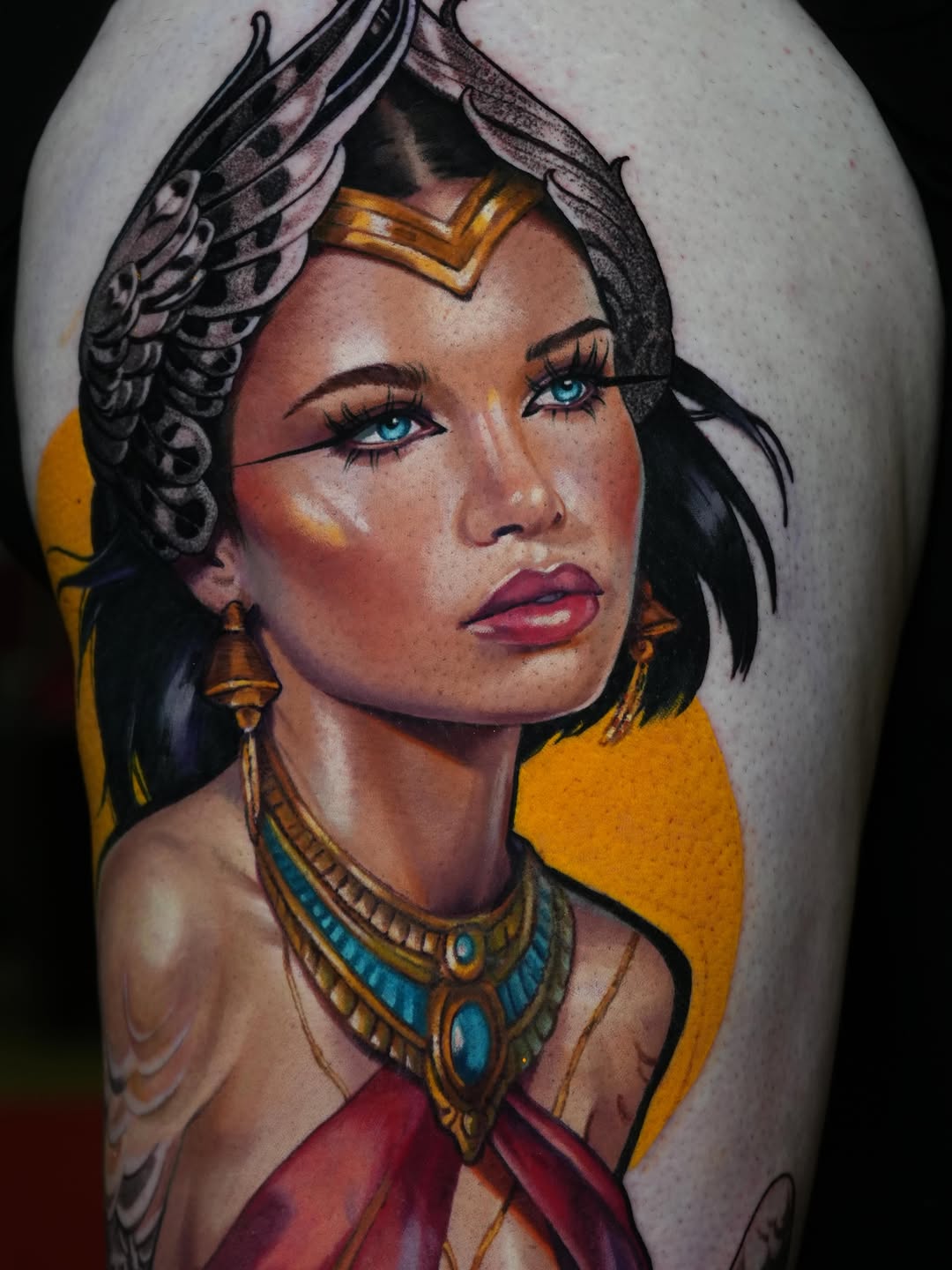 Woman with headdress and jewelry realism tattoo on the upper arm by Daria Pirojenko