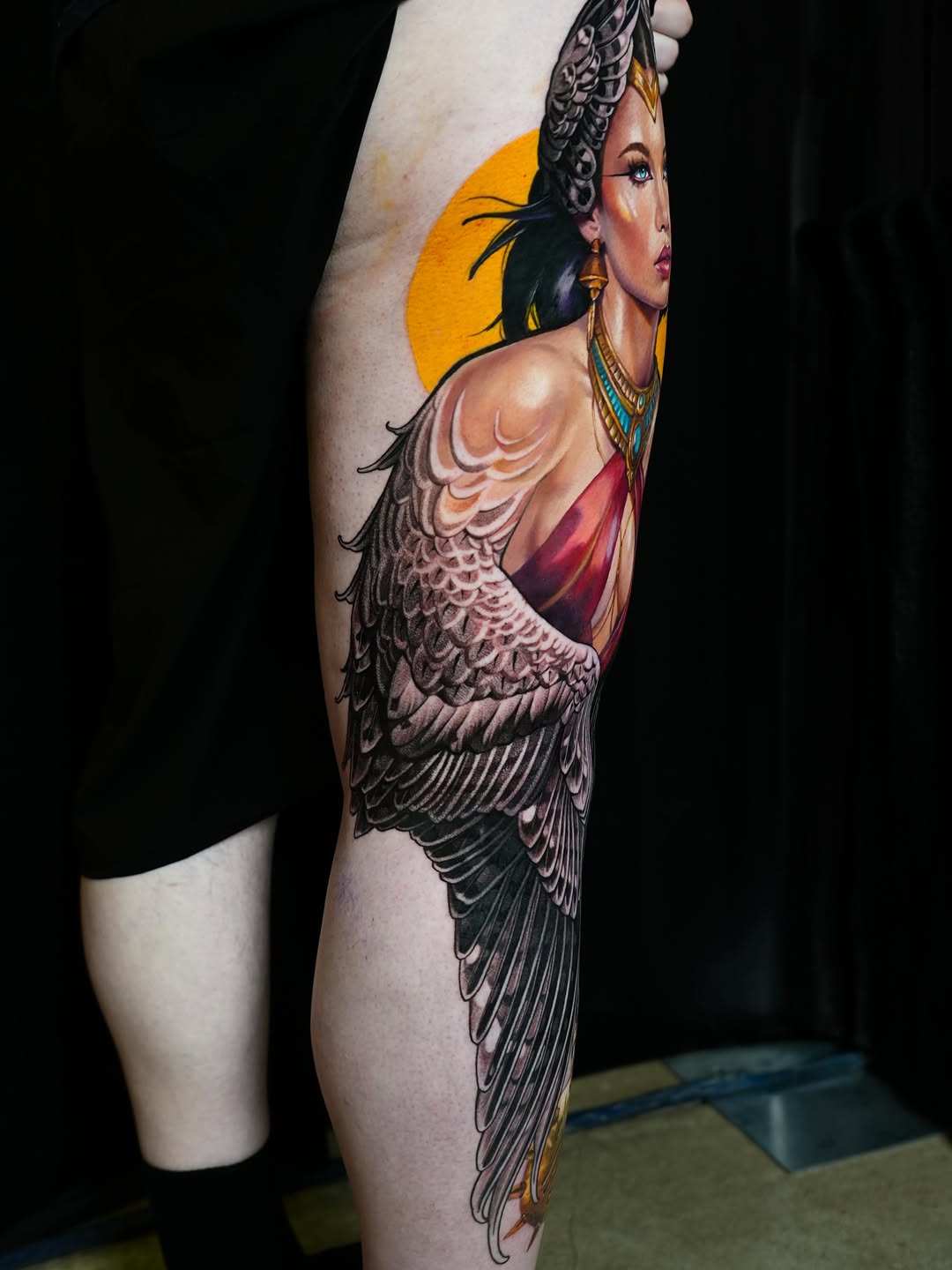 Woman with wings neo-traditional tattoo on the thigh by Daria Pirojenko