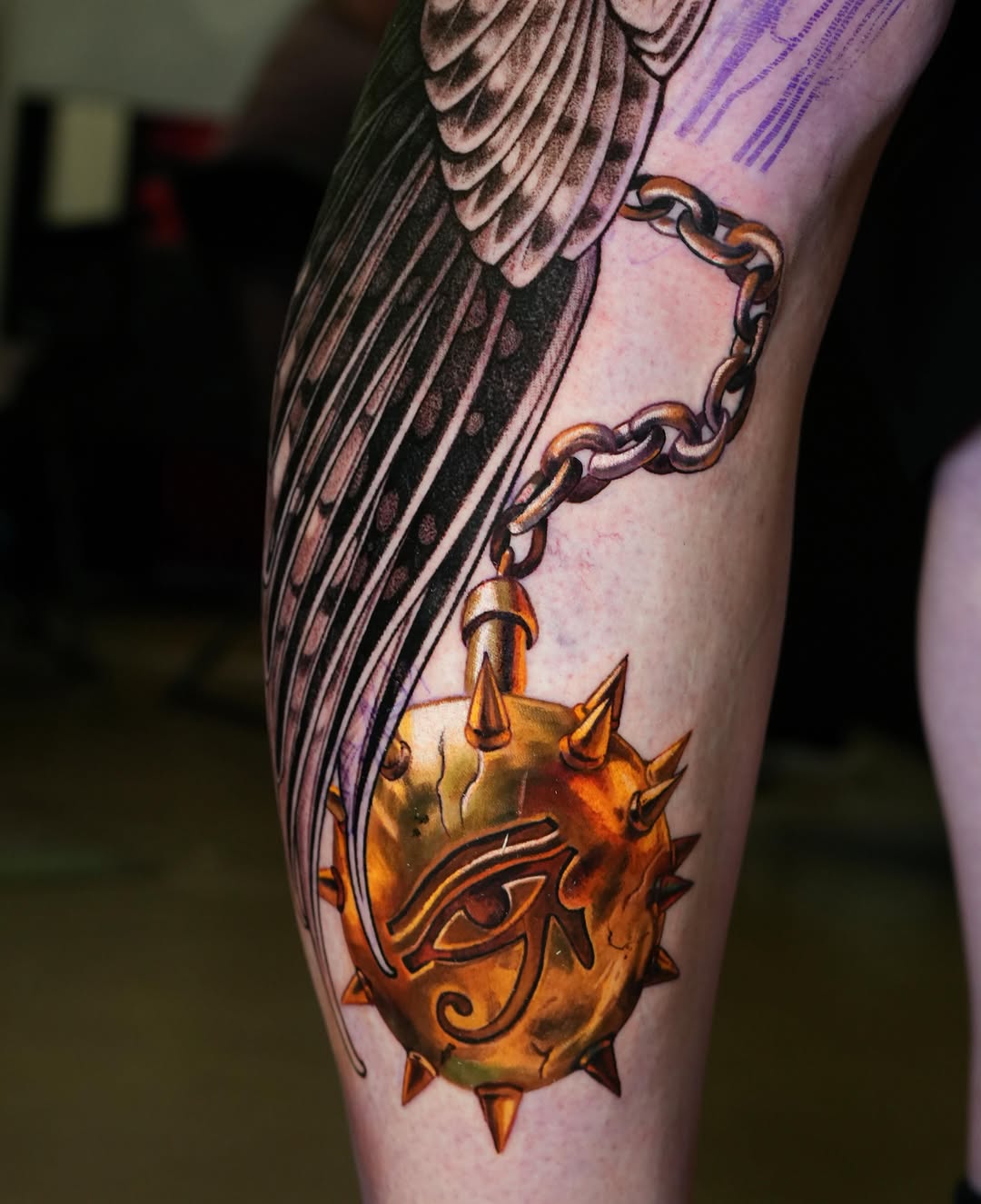 Egyptian eye of Horus pendant surrealism tattoo on the forearm by Daria Pirojenko