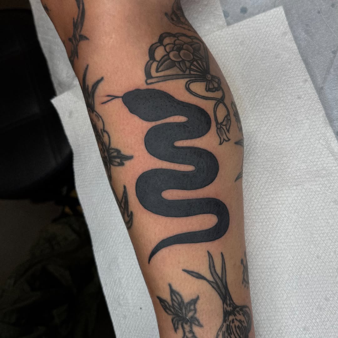 Snake black and grey tattoo on the forearm by nicky joe