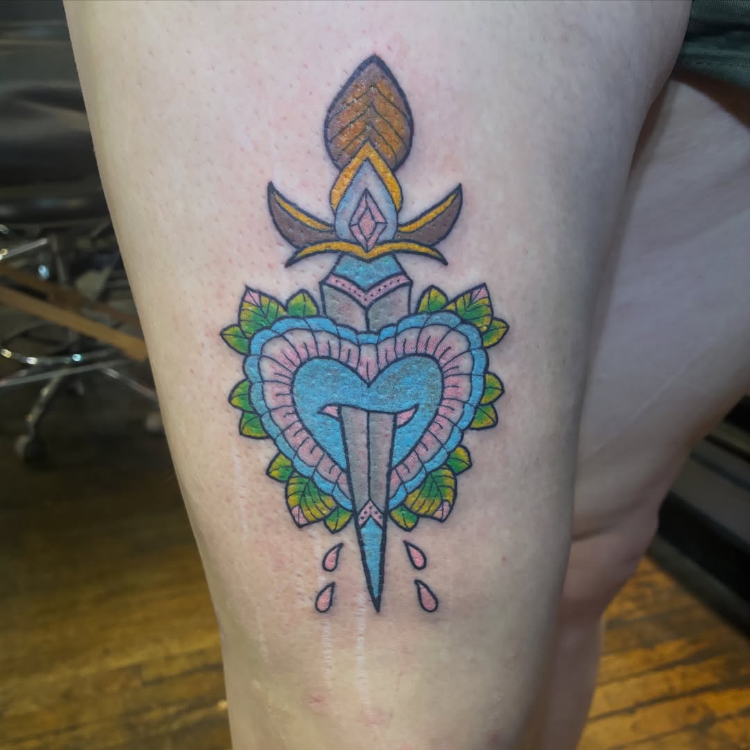 Heart with dagger American traditional tattoo on the leg by Seattle Tattoo Artist