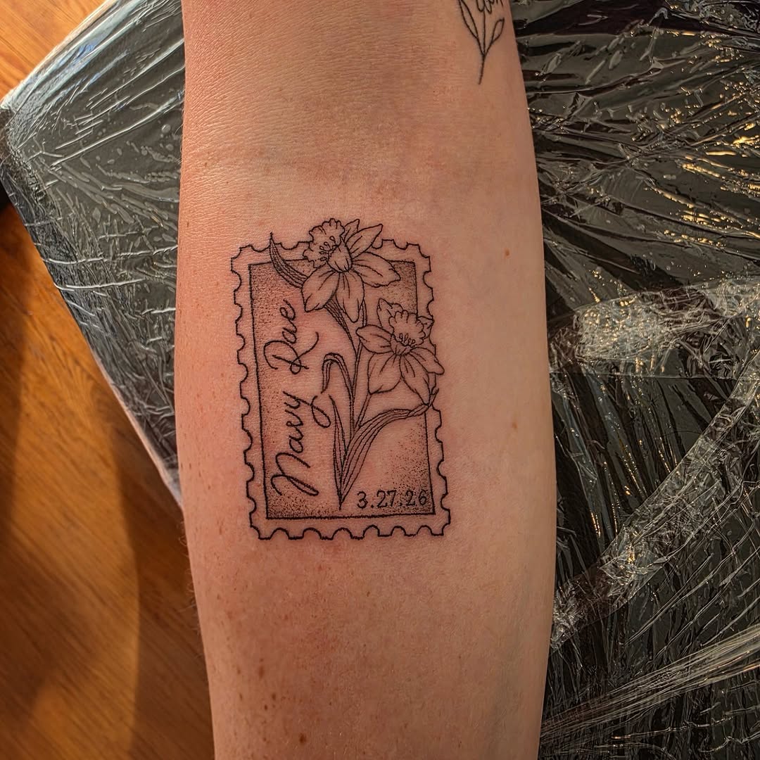 Stamp with daffodils and text minimalist tattoo on the forearm by Solstice Tattoos by Savannah Sadler (future, Salisbury, North Carolina