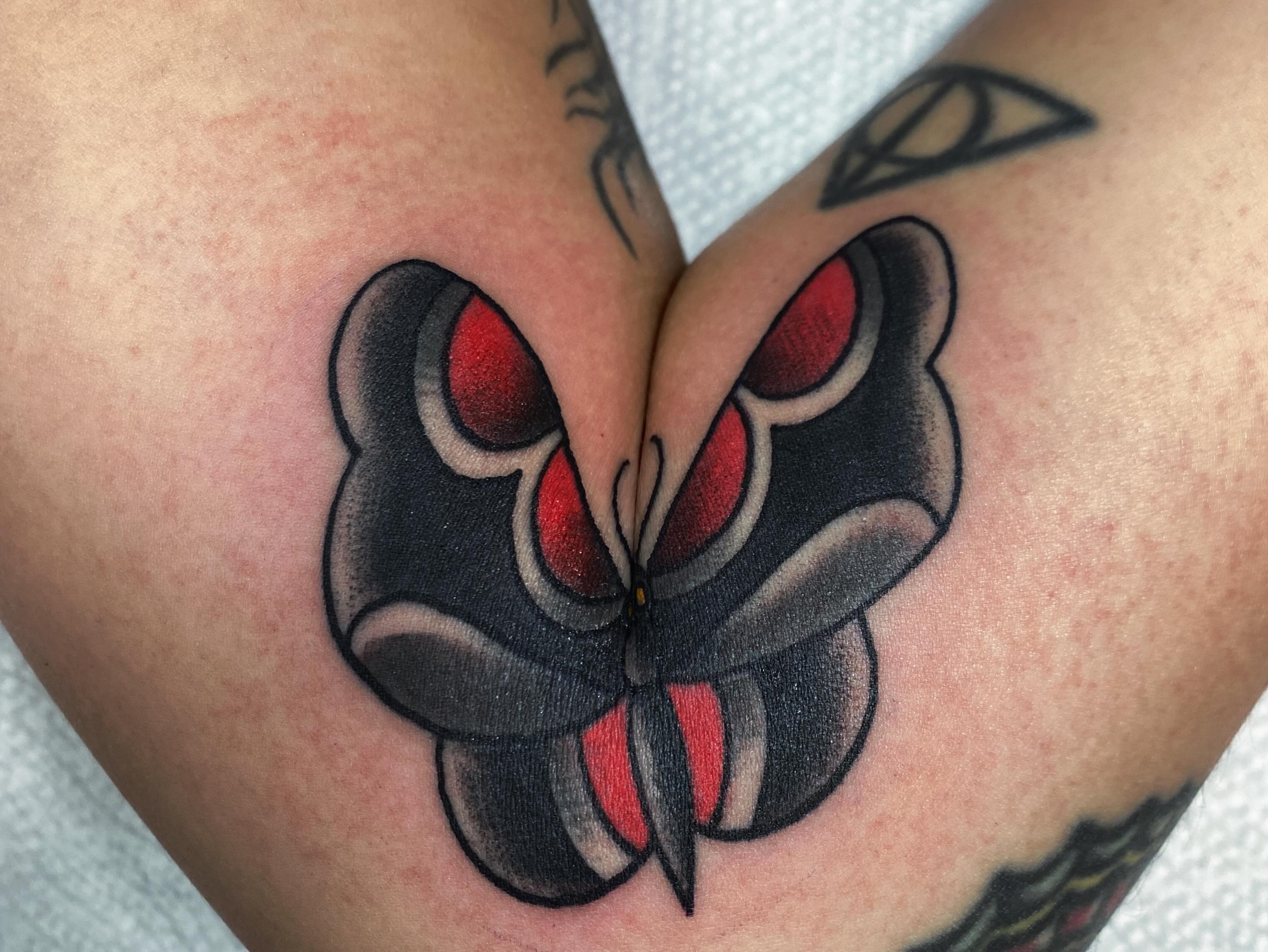 Butterfly American traditional tattoo on the thigh by Houston tattoo artist