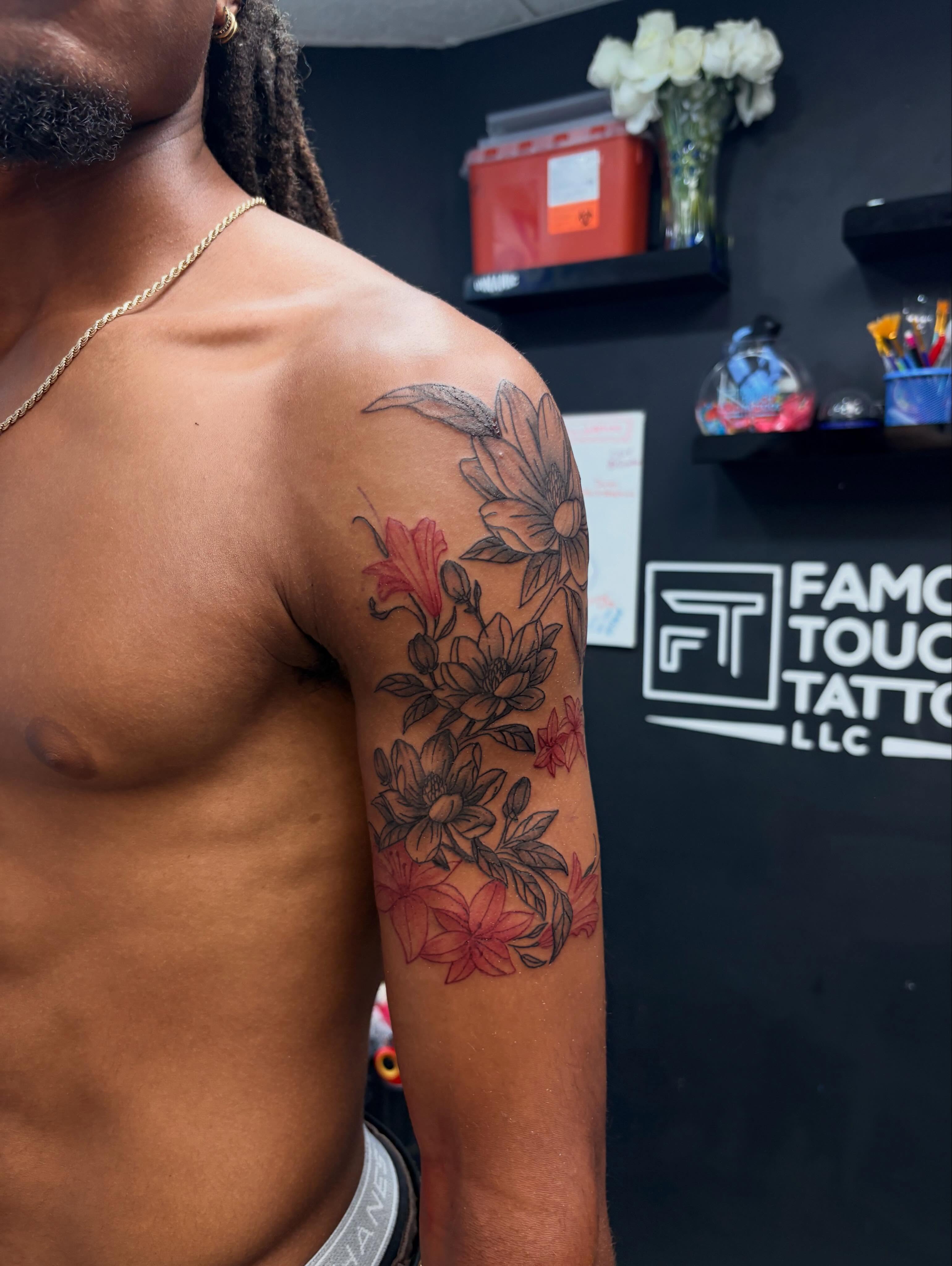 Floral bouquet black and grey tattoo on the upper arm by 𝓚𝓪𝓻𝓶𝓪💫
