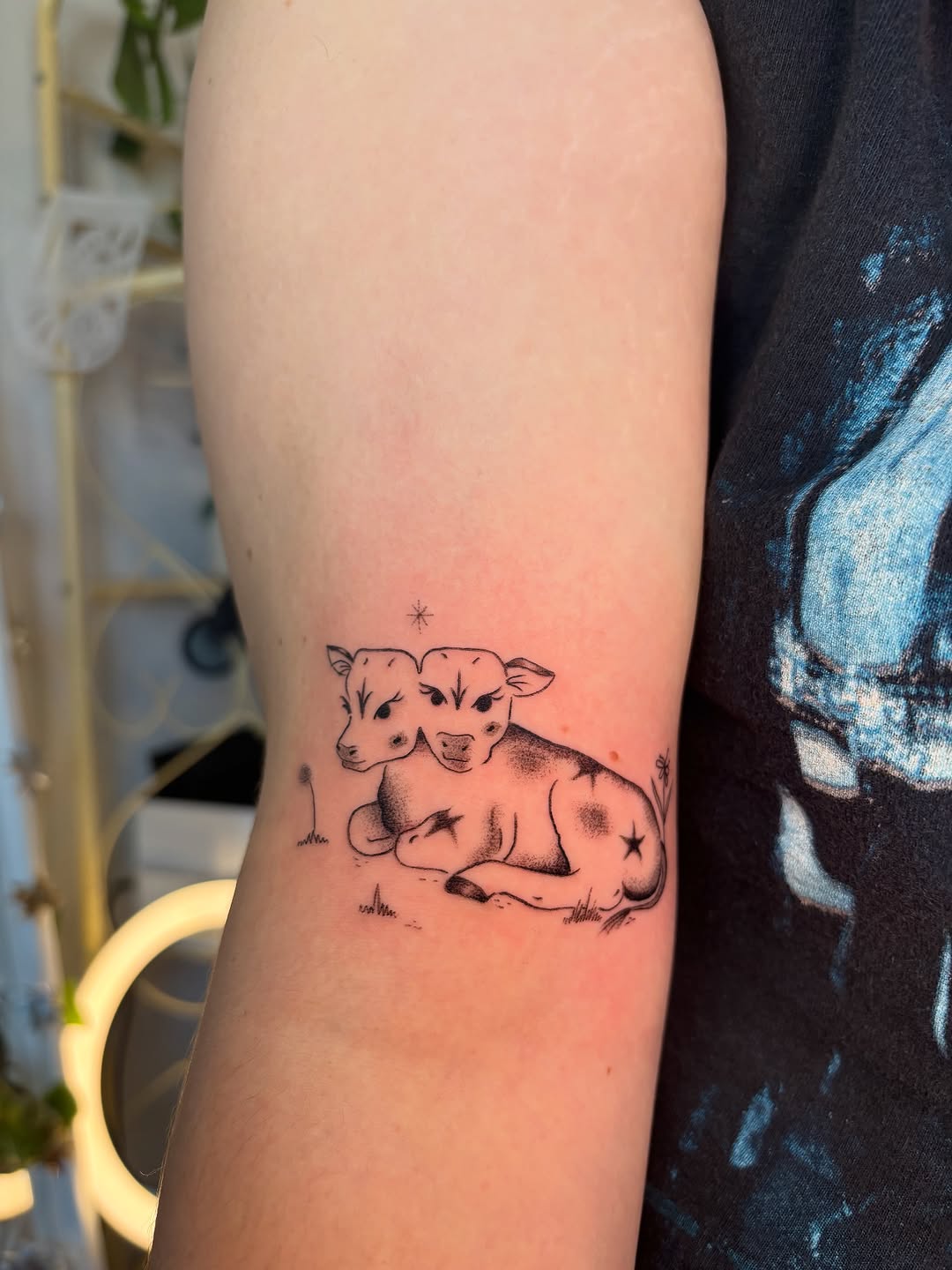 Two-headed calf fine line tattoo on the forearm by carla sofia