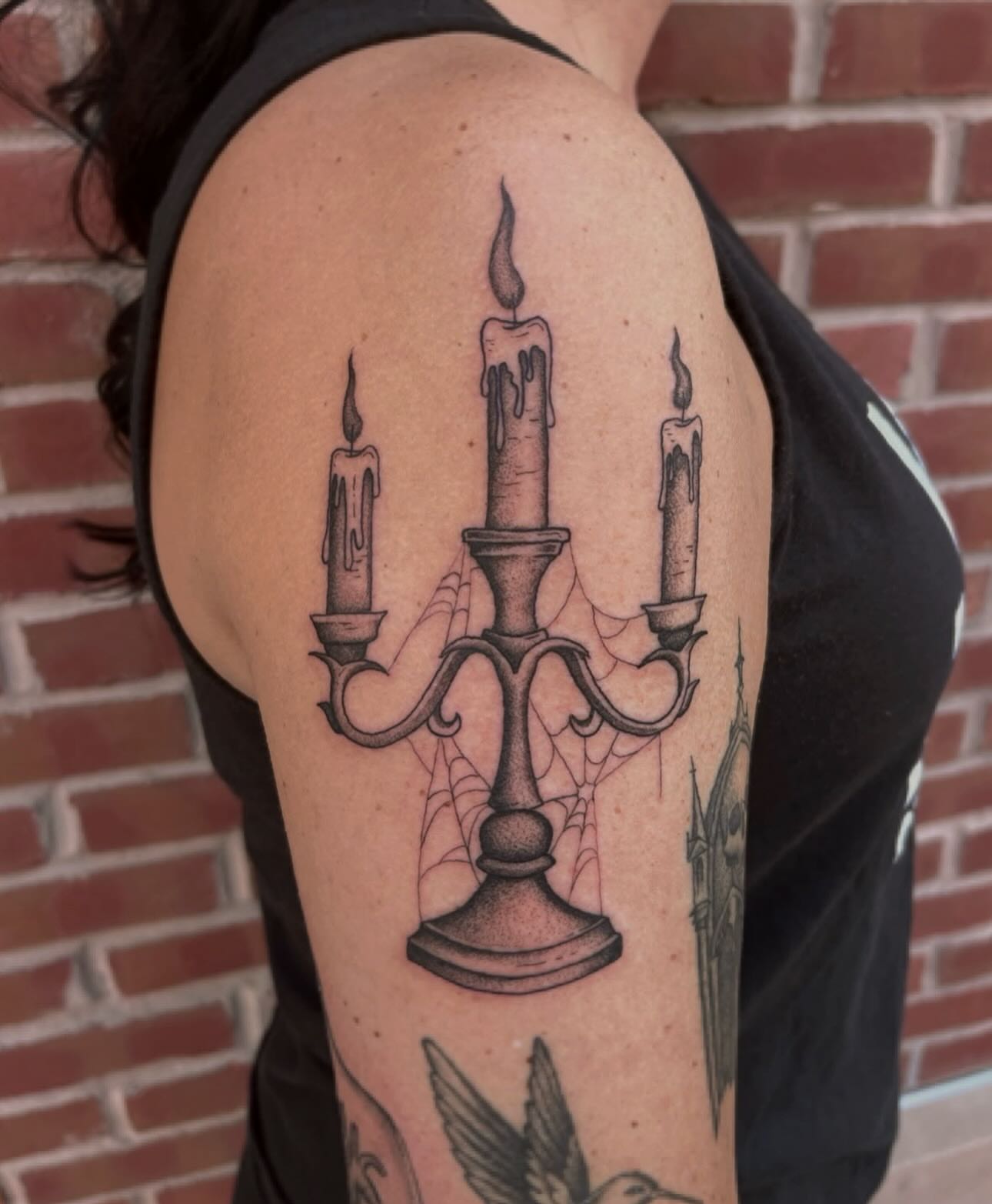 Candle chandelier black and grey tattoo on the upper arm by Jackson Kirchhoff