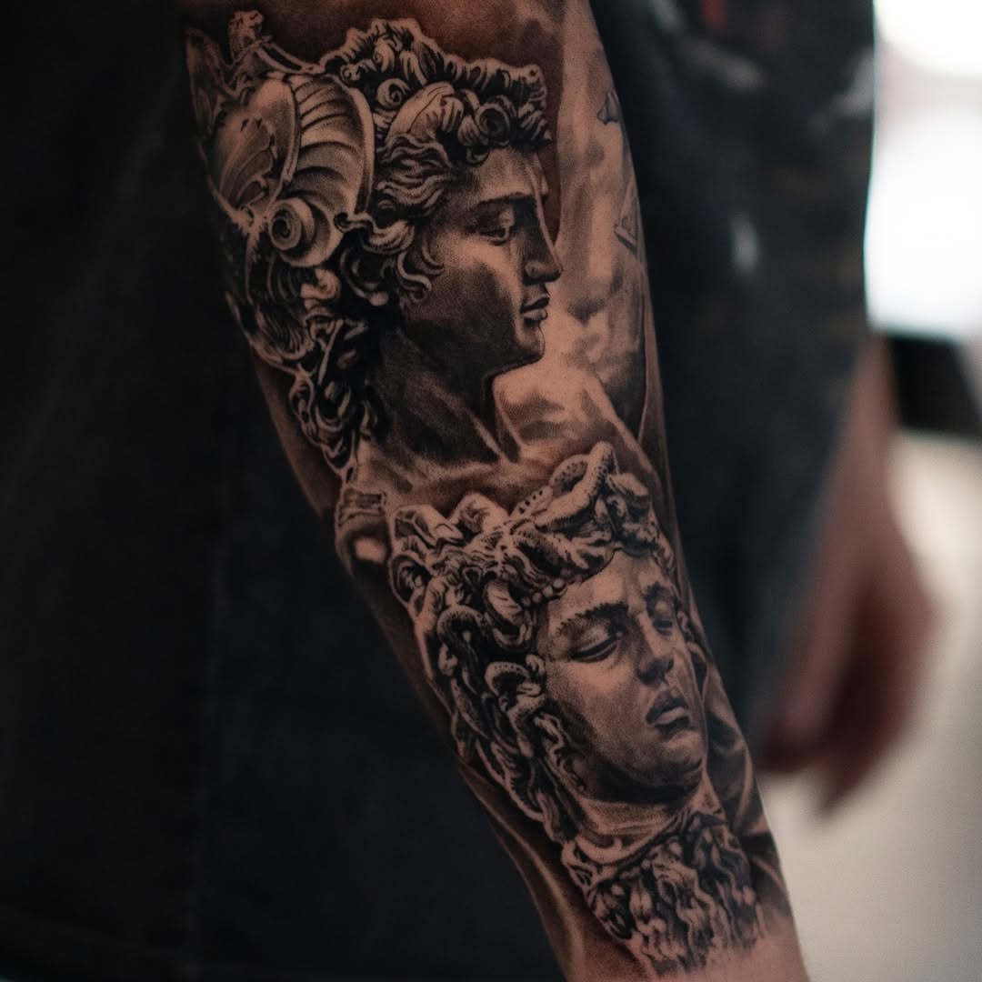 Classical statues realism tattoo on the forearm by Mark Vata