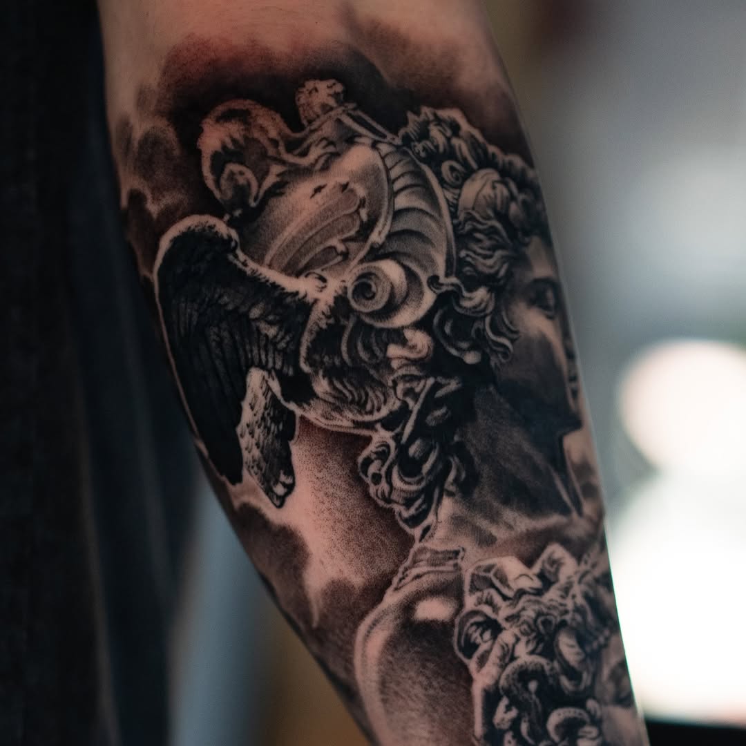 Angelic statue realism tattoo on the forearm by Mark Vata