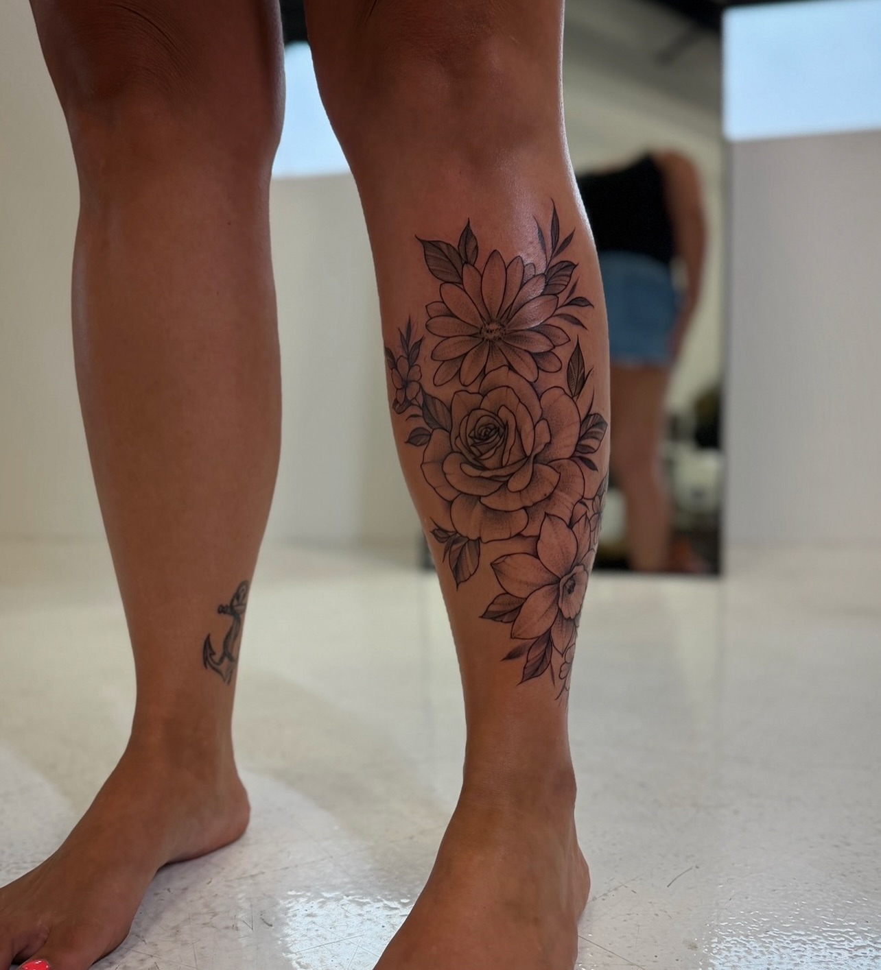 Floral bouquet black and grey tattoo on the calf by Rikky Bobby, Mesa, Arizona