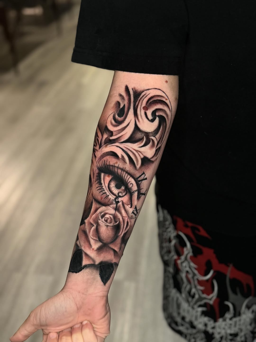 Eye and rose with clock Chicano tattoo on the forearm by Adrián Banuelos