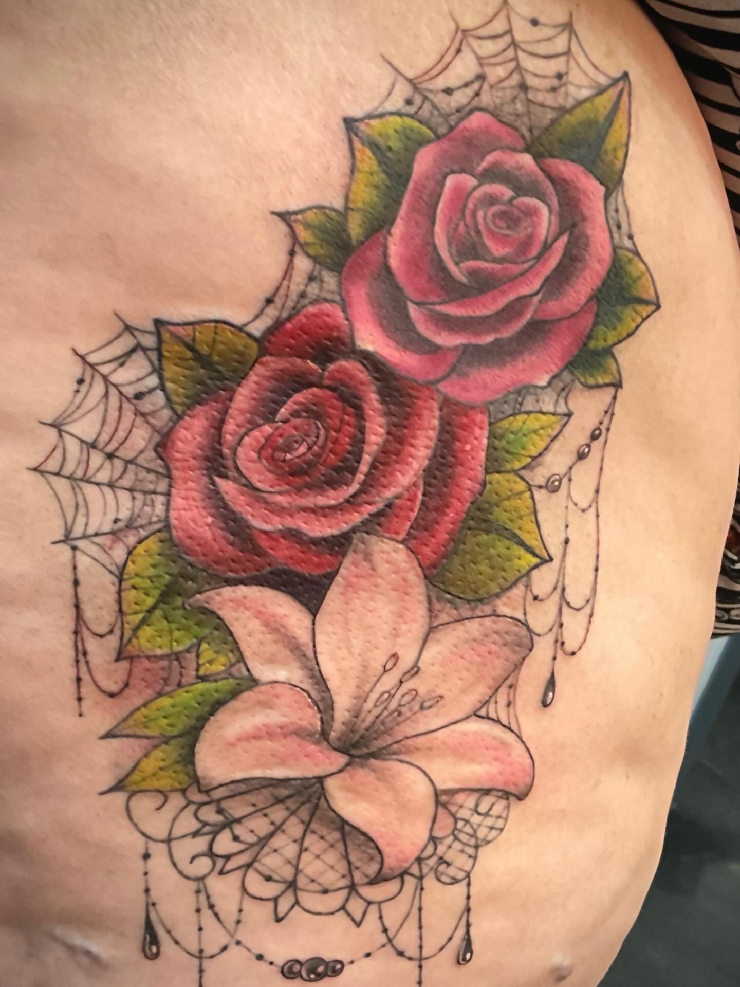 Roses and lily American traditional tattoo on the chest by Freya Petersen