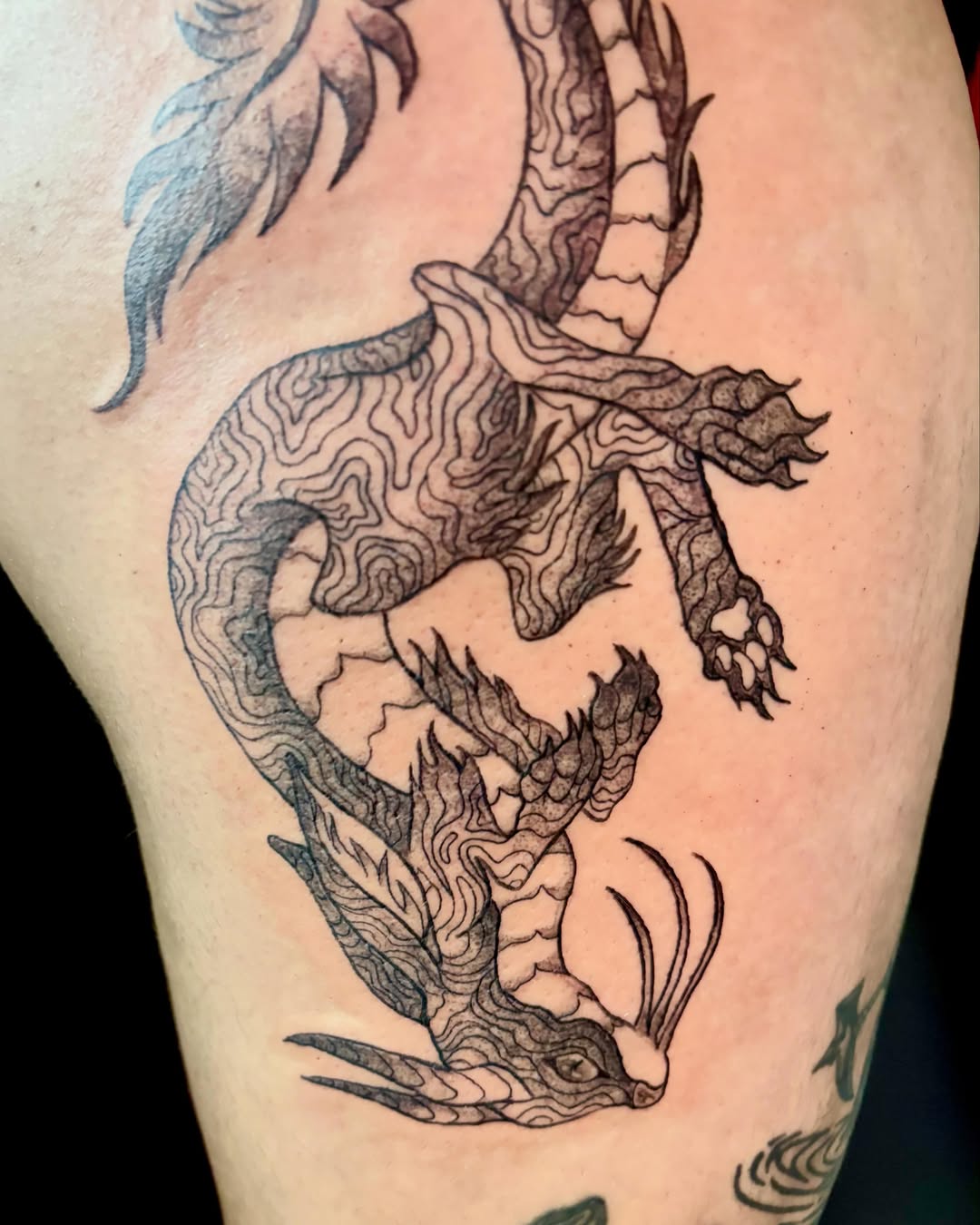 Dragon black and grey tattoo on the thigh by Abby Ruok, Midvale, Utah