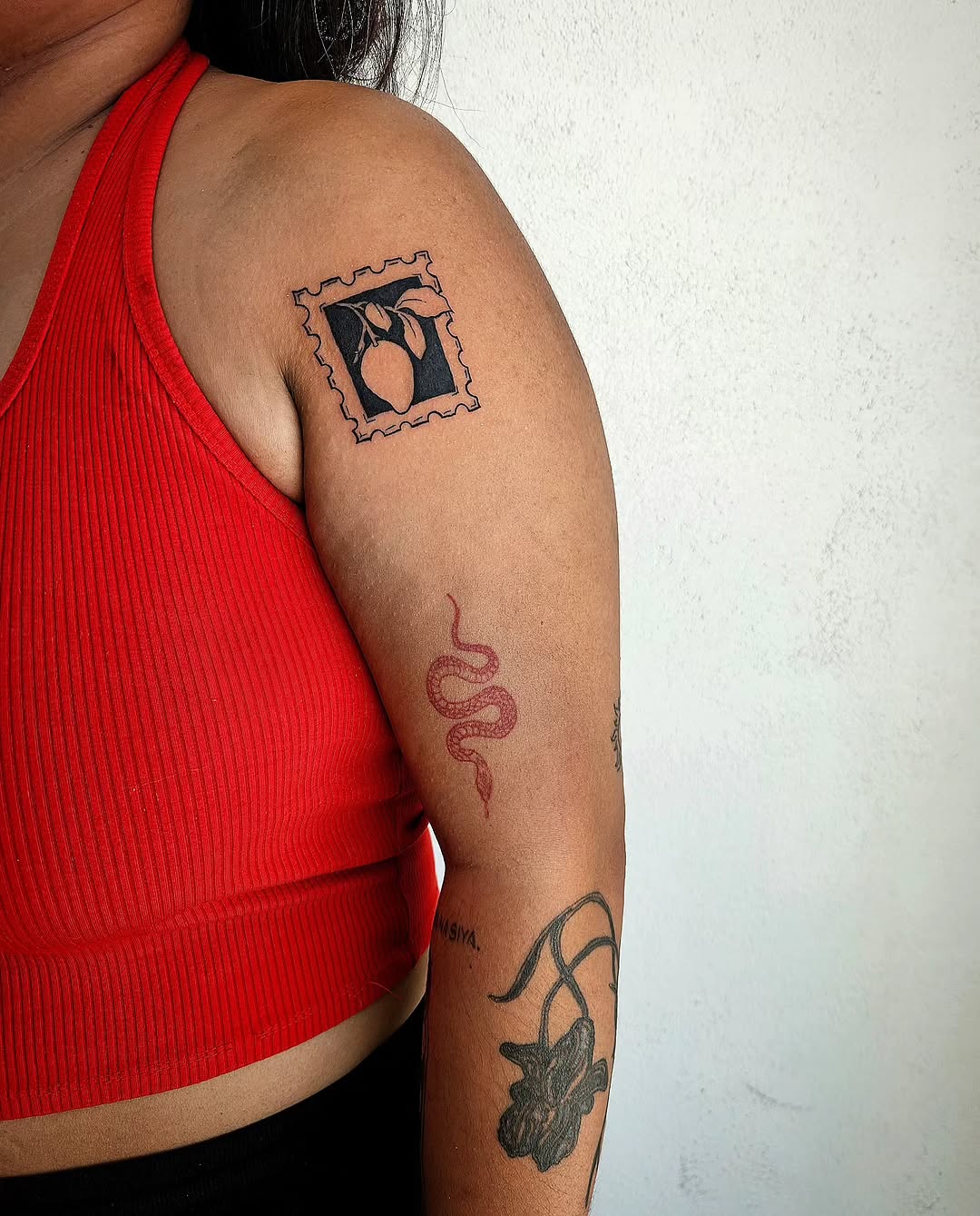 Stamp with fruit minimalist tattoo on the upper arm by Lina ๐ป