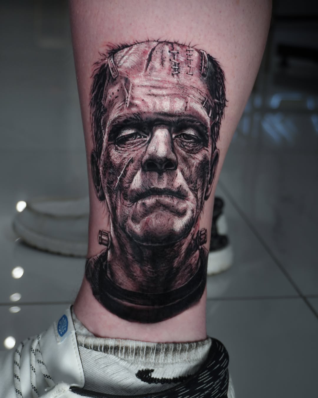 Frankenstein's monster portrait realism tattoo on the calf by Alberto Marrero