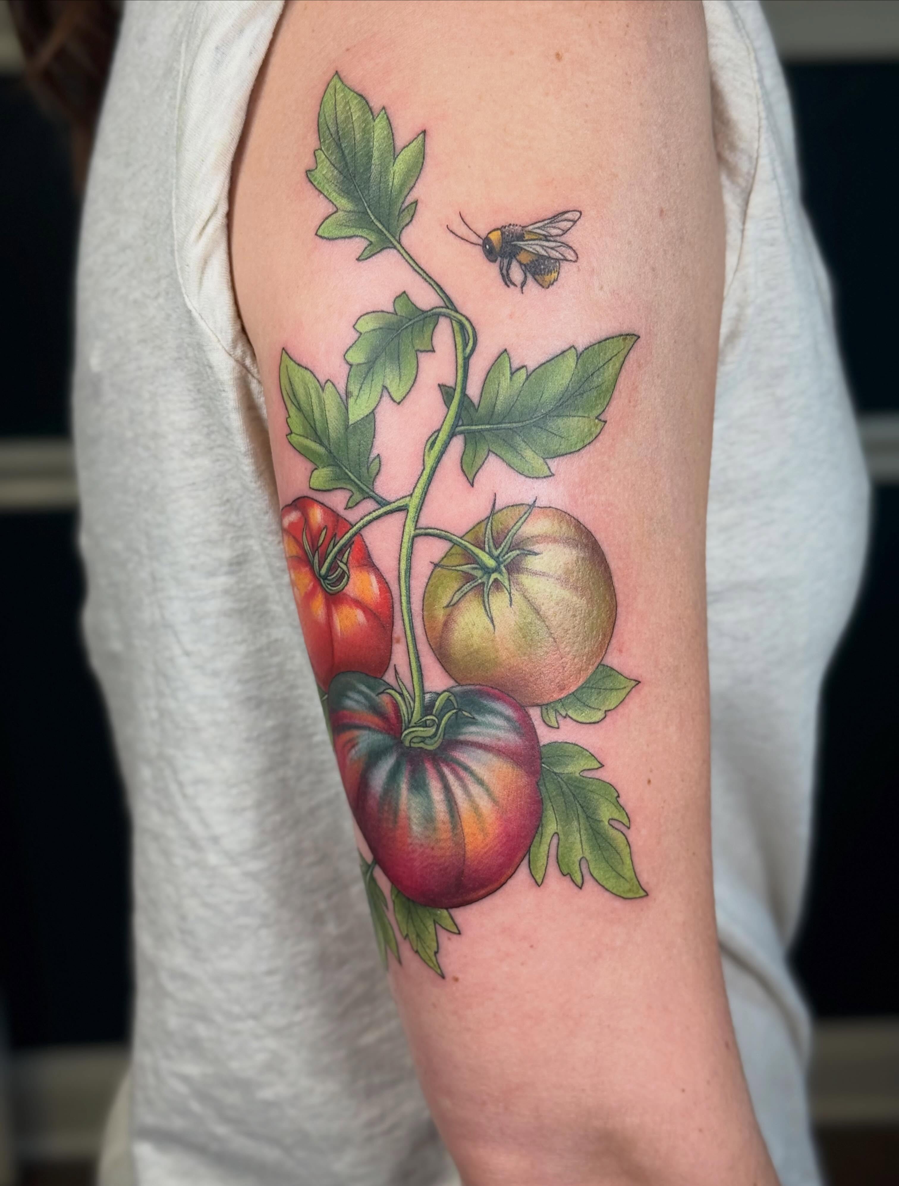 Tomatoes and bee realism tattoo on the forearm by Larkin Resler