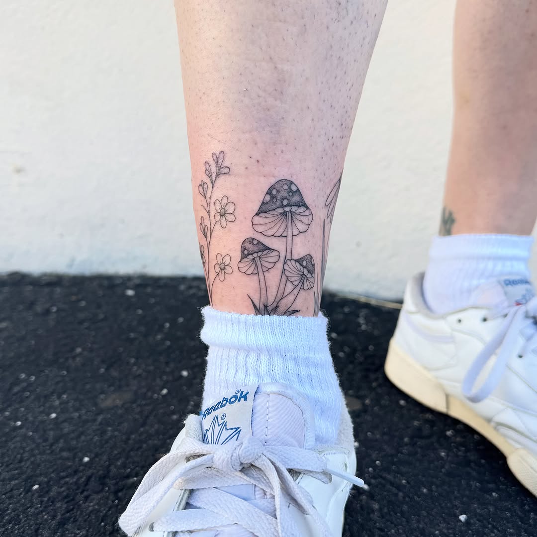 Mushrooms and flowers minimalist tattoo on the calf by Madison Davenport, Saddle Brook, New Jersey