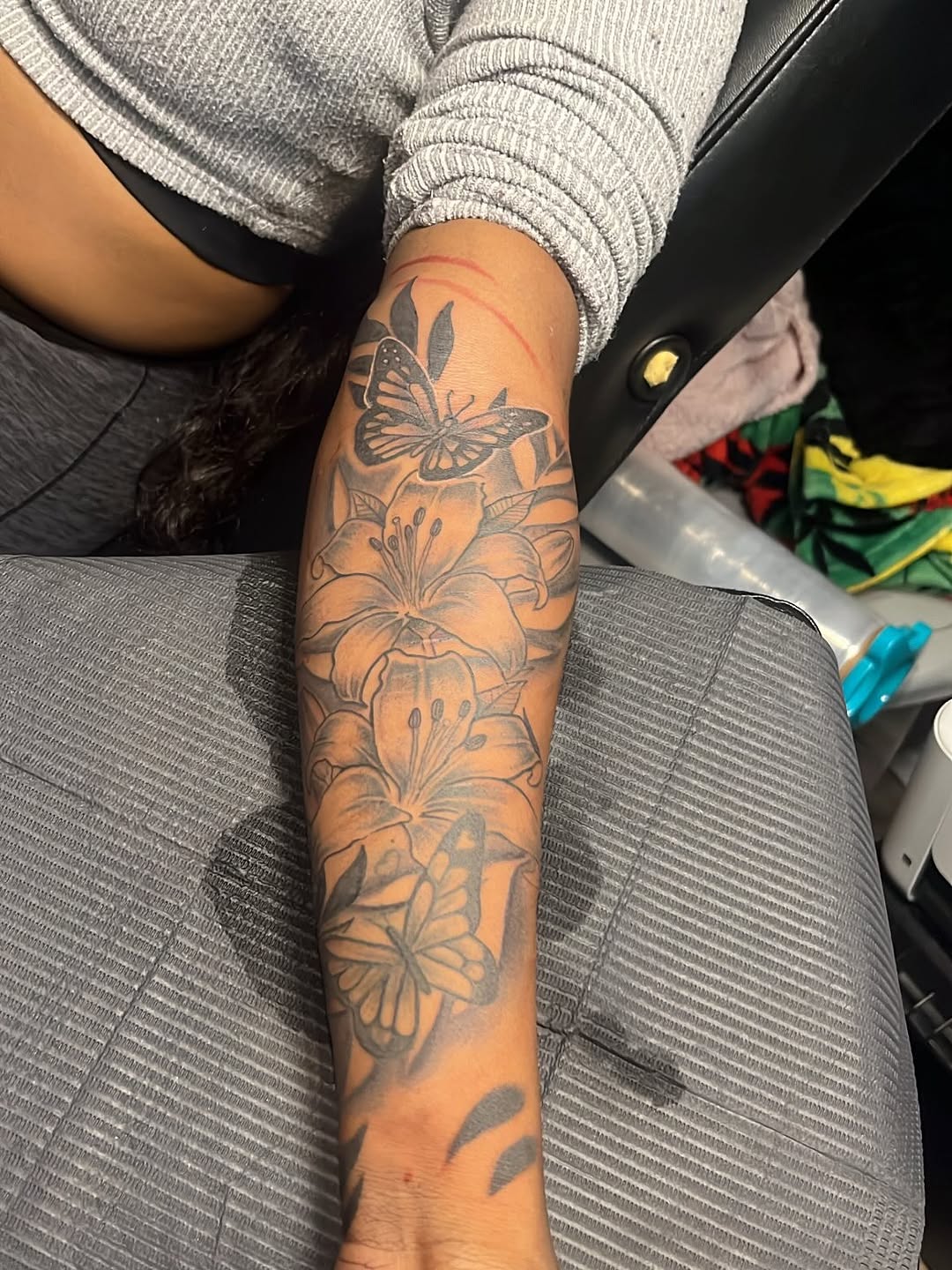 Butterflies and lilies fine line tattoo on the forearm by SpicyMvstardInkk