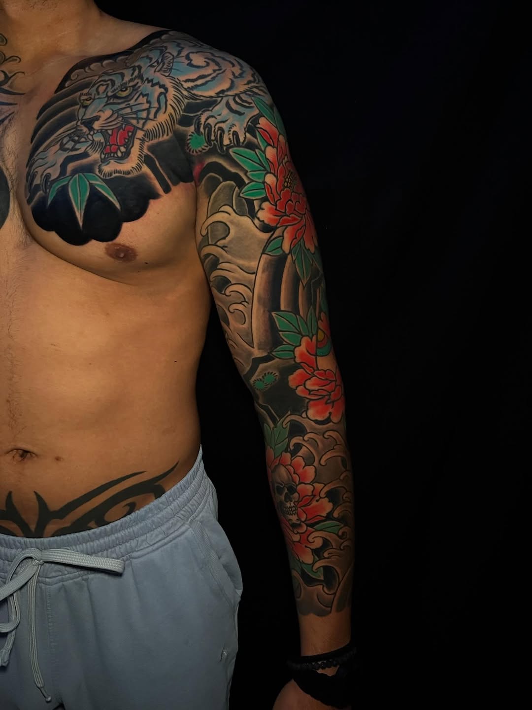 Tiger and peonies Japanese tattoo on the upper arm by Andrew Snowden