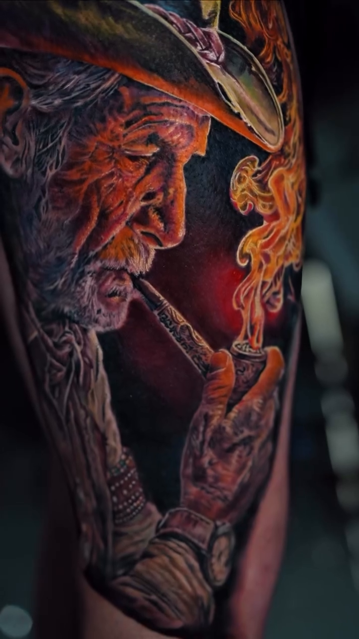 Surrealism tattoo on the upper arm by Alberto M