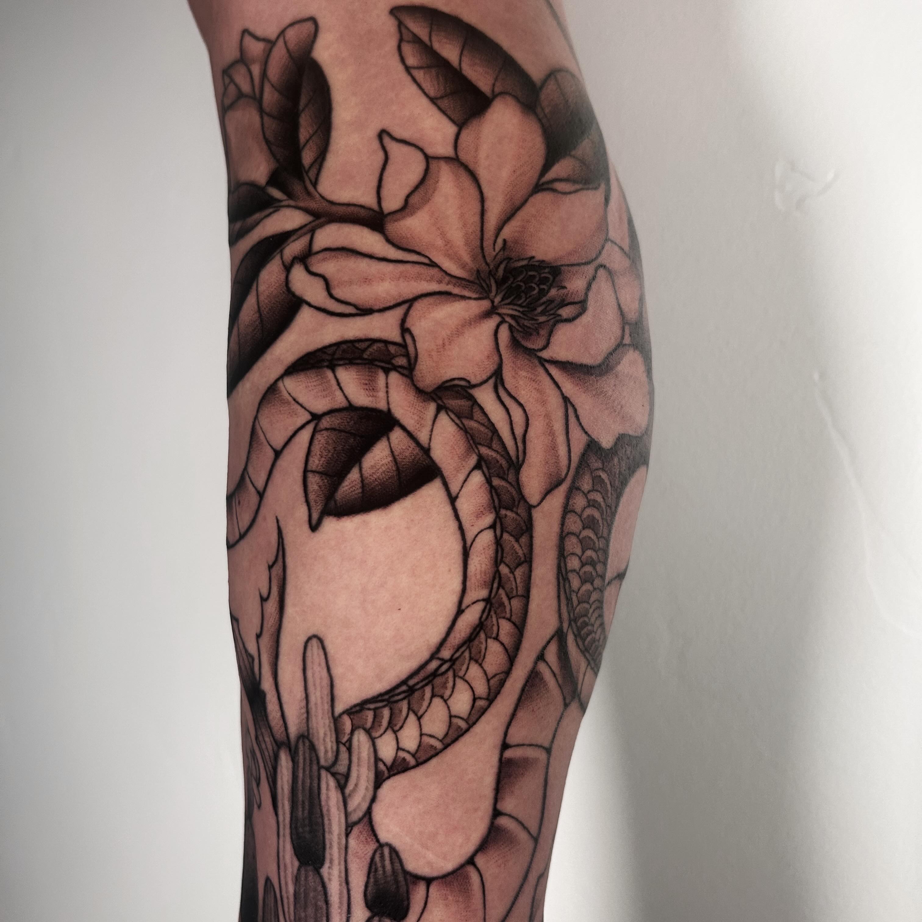 Snake and flower realism tattoo on the forearm by Salt Lake City tattoo artist