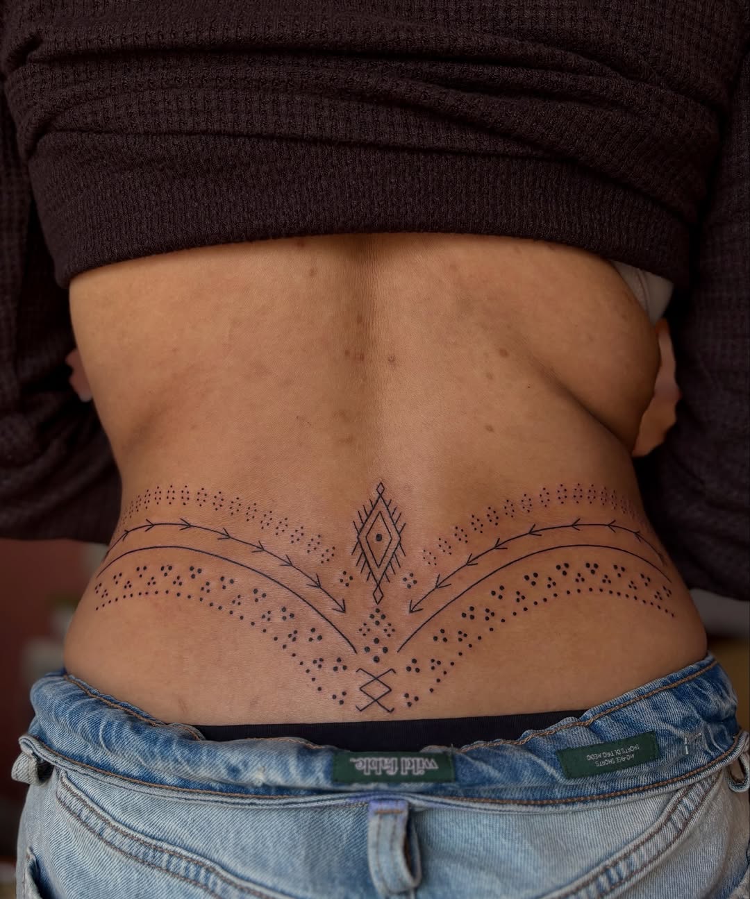 Geometric pattern with dots dotwork tattoo on the torso by Olivia D’Amore