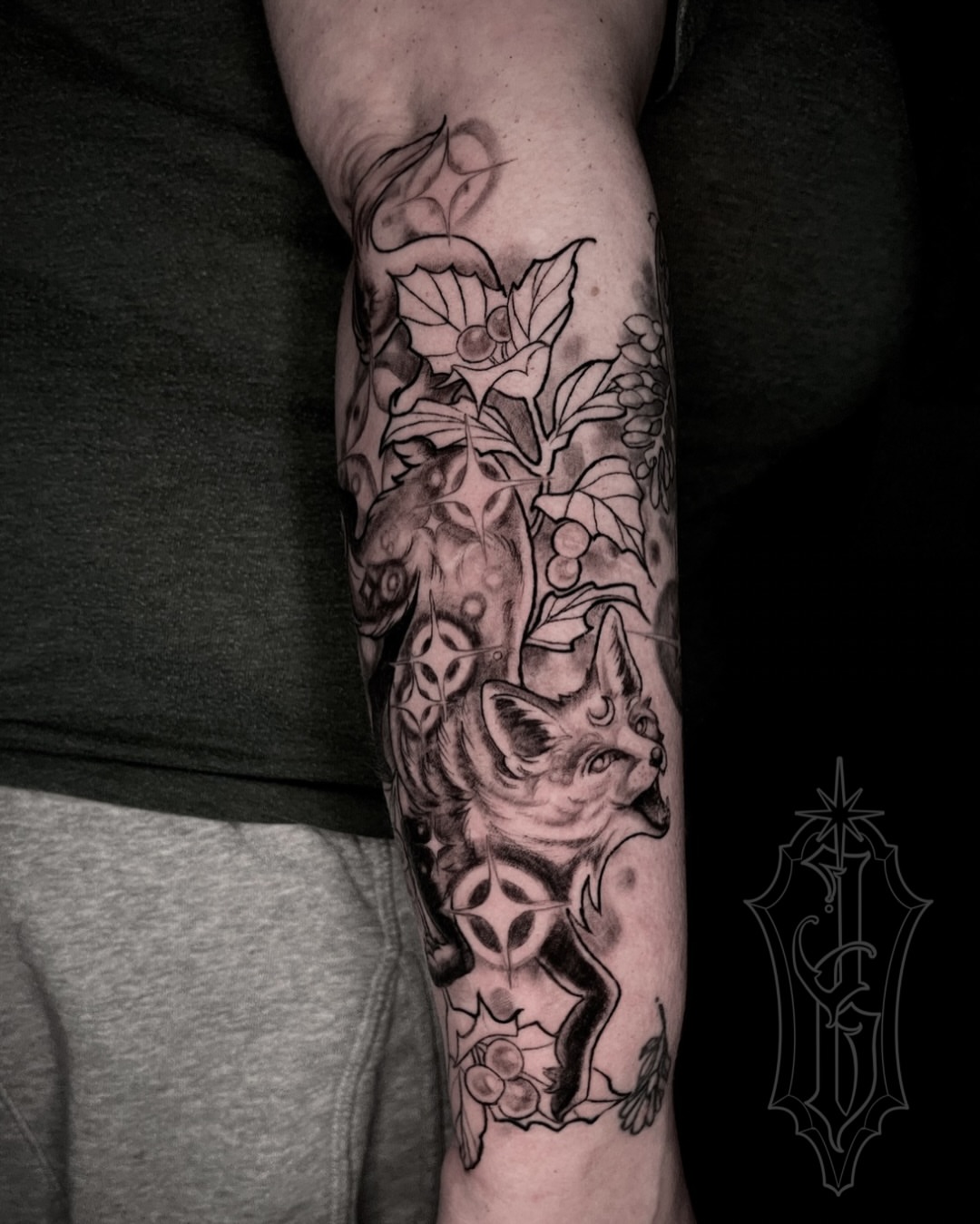 Cat and floral realism tattoo on the forearm by Jessica Burridge