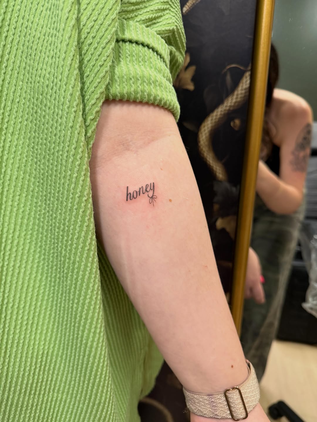 Honey lettering with bow lettering tattoo on the forearm by Fineline Tattoos π€ Hailey L.