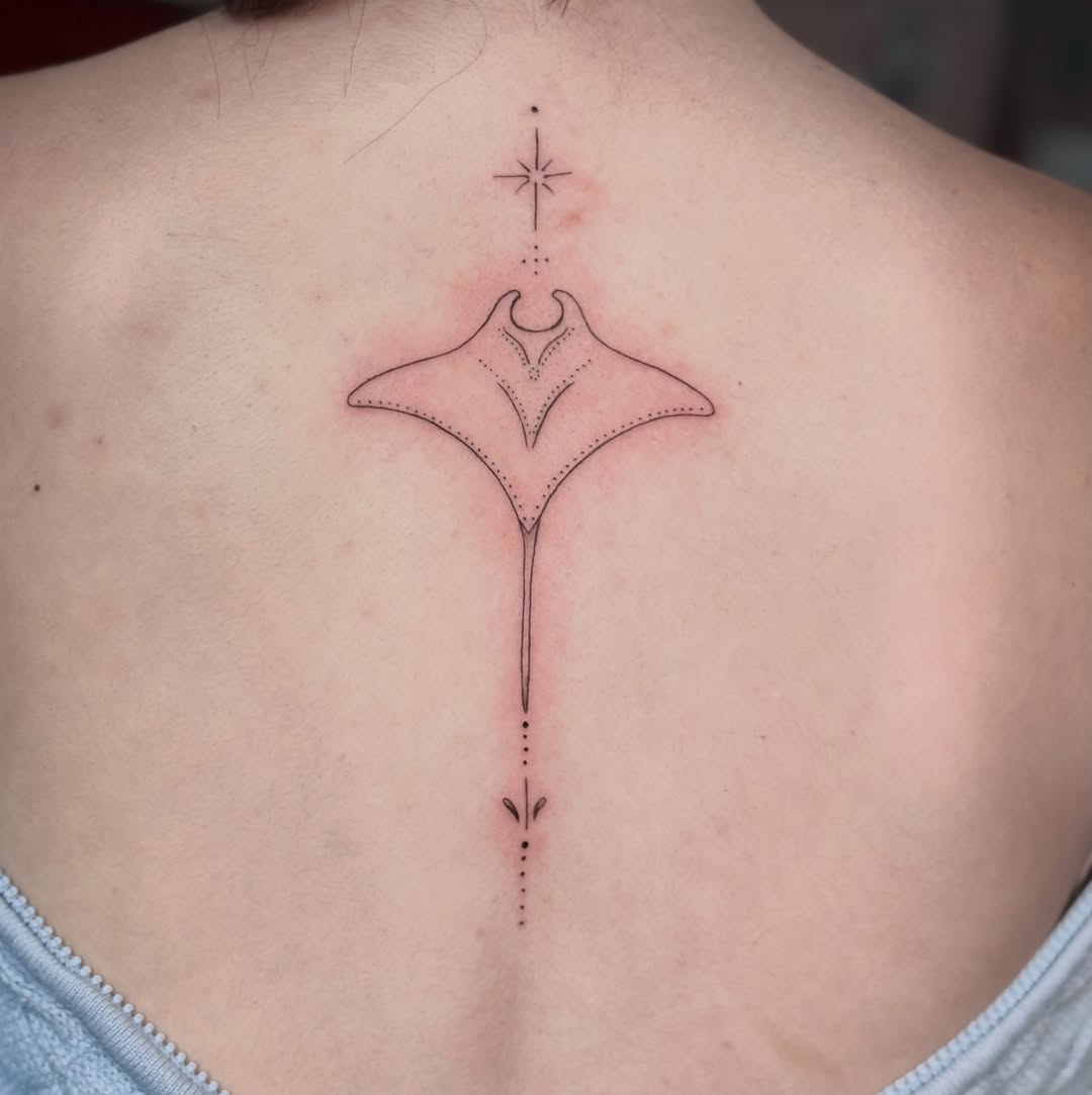 Manta ray with star fine line tattoo on the back by Jennifer Ramirez