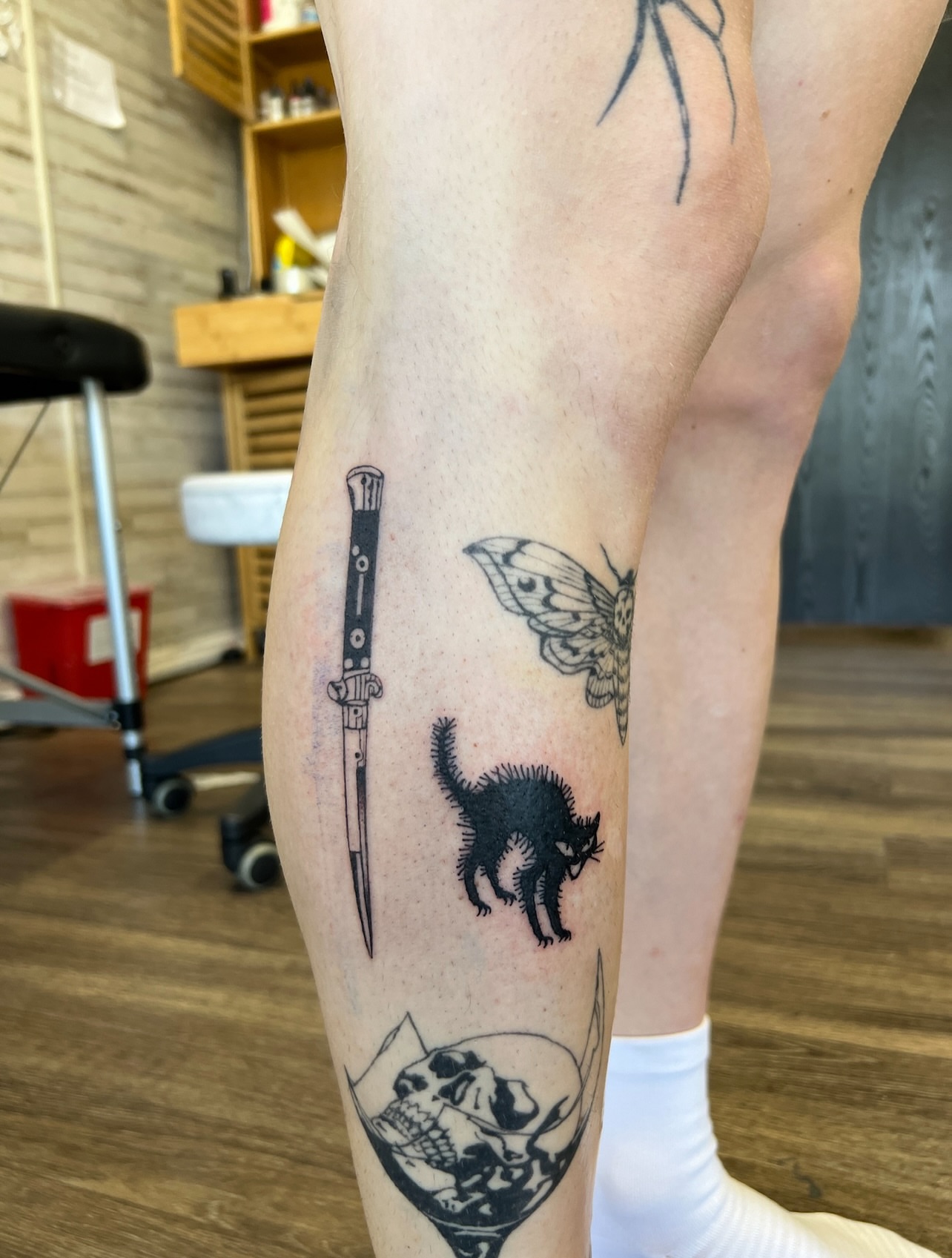 Cat and moth black and grey tattoo on the leg by Utah Tattoo Artist - Gwen White