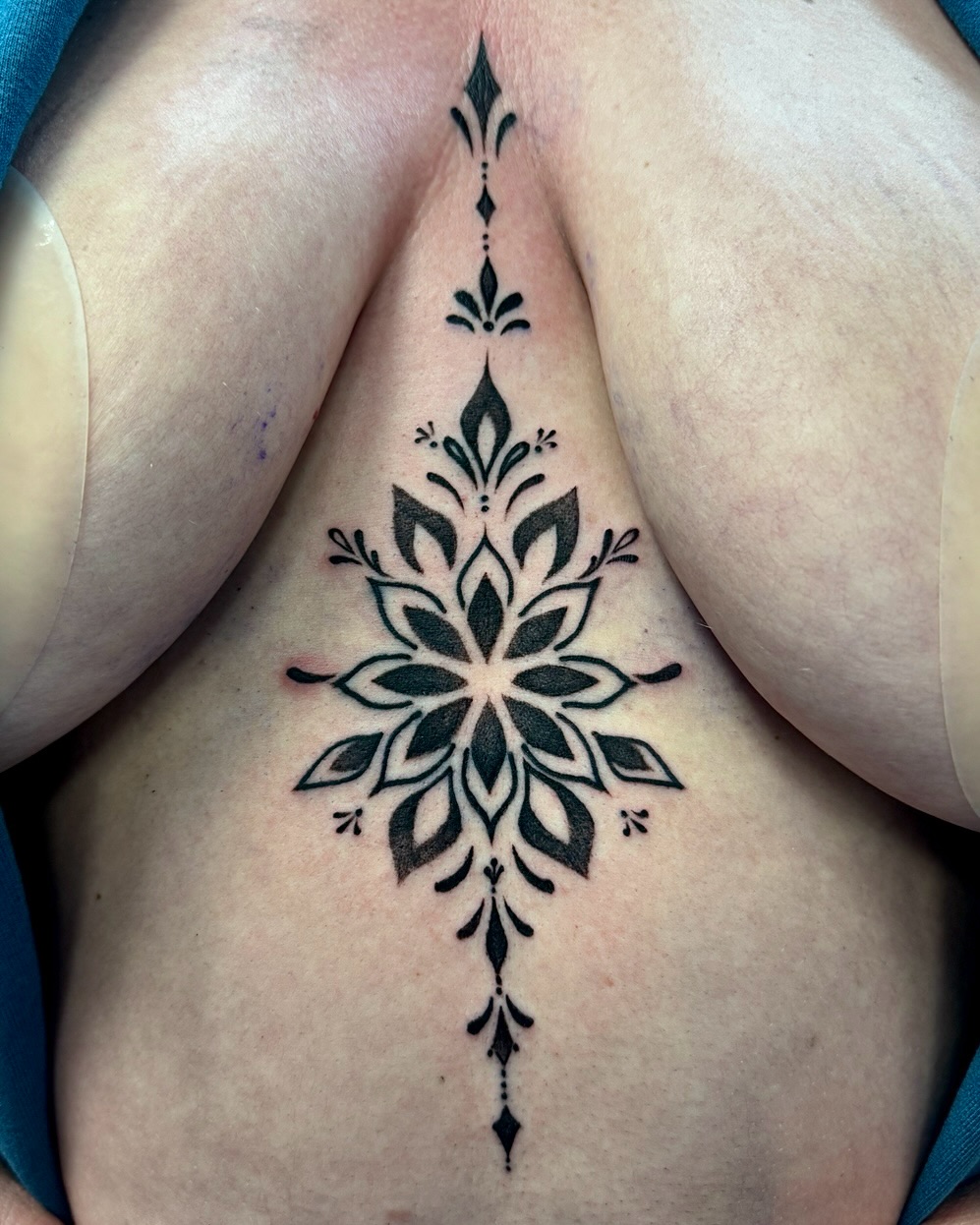 Mandala sternum piece dotwork tattoo on the chest by David