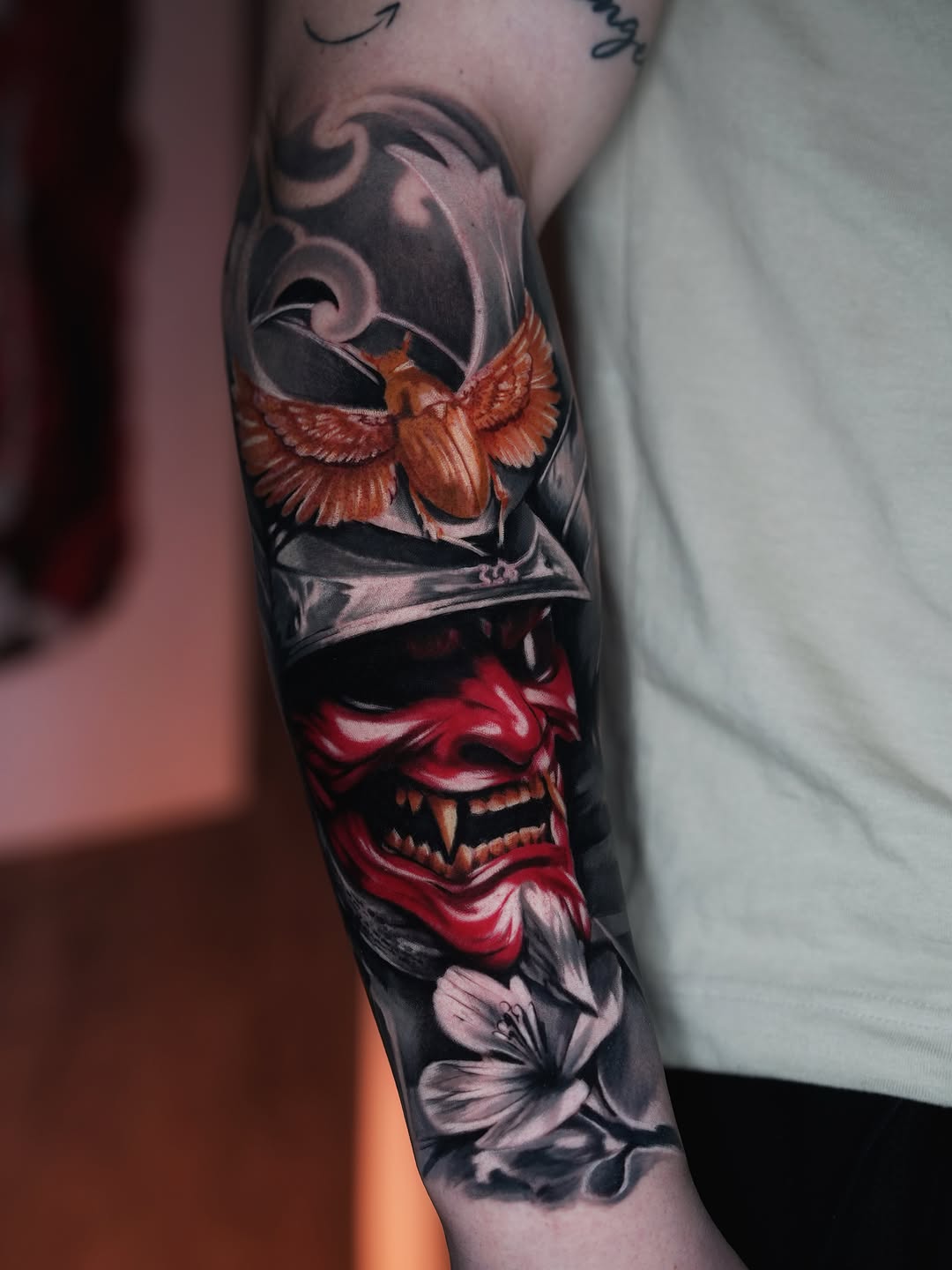 Samurai mask with beetle and flower Japanese tattoo on the forearm by Andres García Baeza