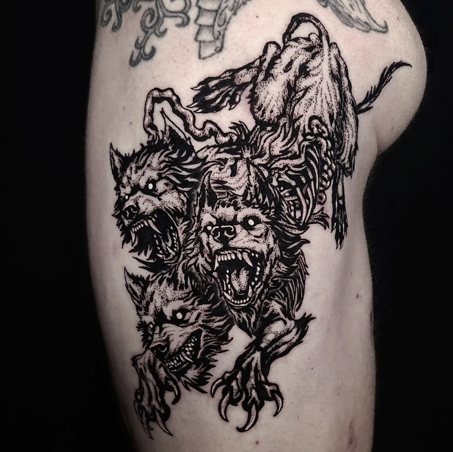 Monstrous beast dotwork tattoo on the thigh by Alex Stairs