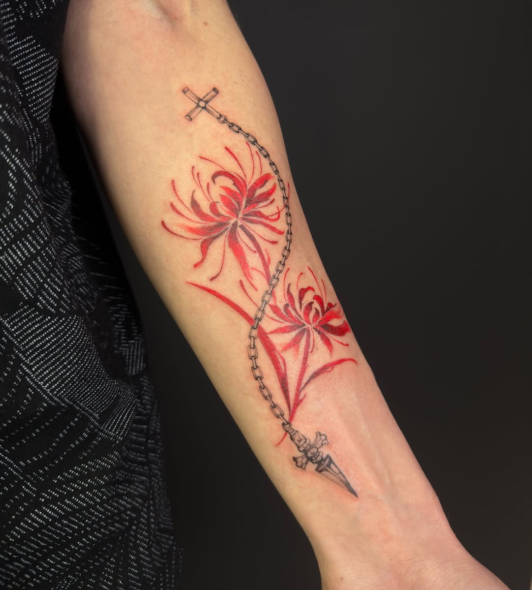 Spider lilies with chain and dagger watercolor tattoo on the forearm by Vu Nguyen
