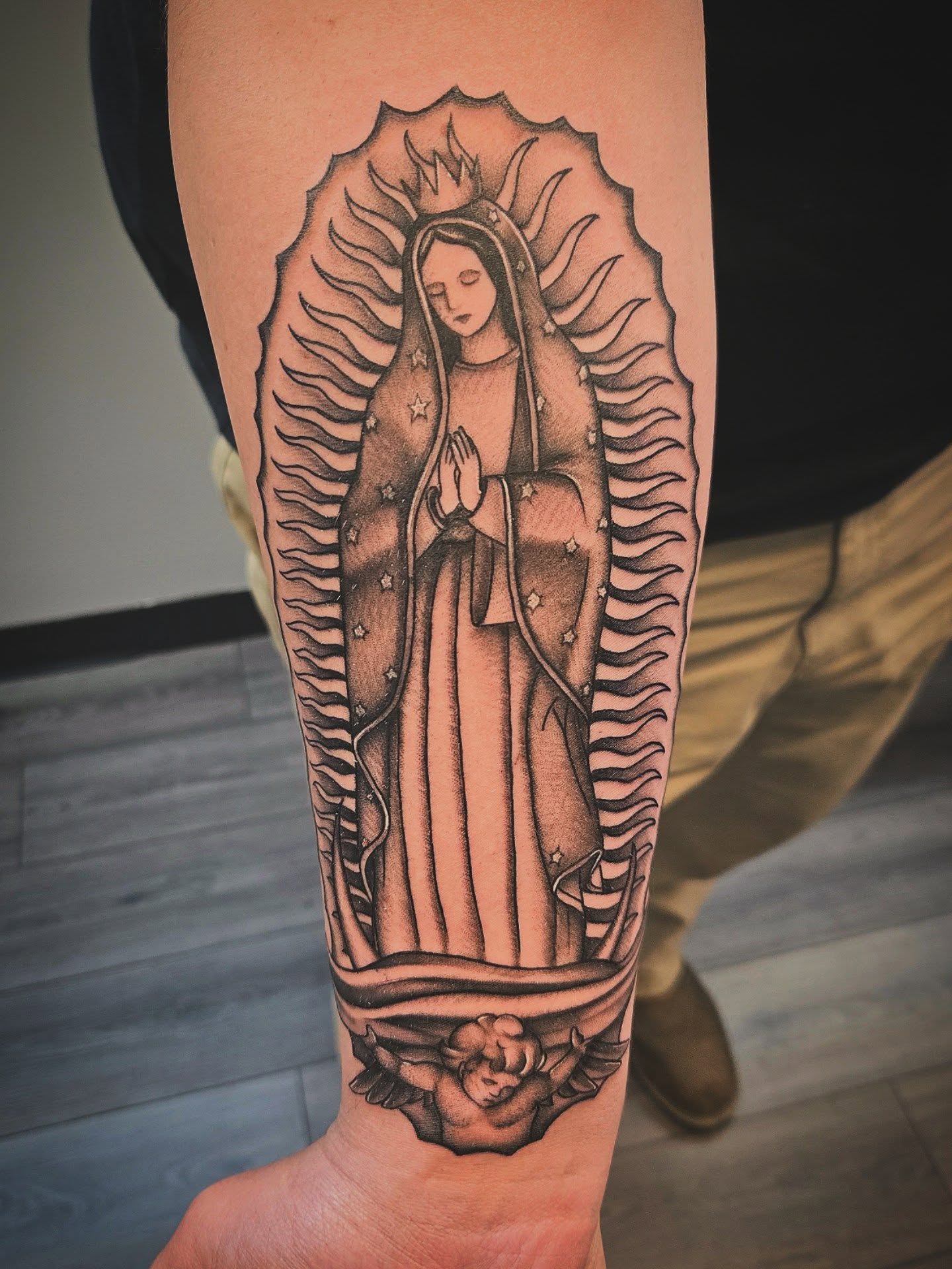 Our Lady of Guadalupe black and grey tattoo on the forearm by Danielle Elizabeth