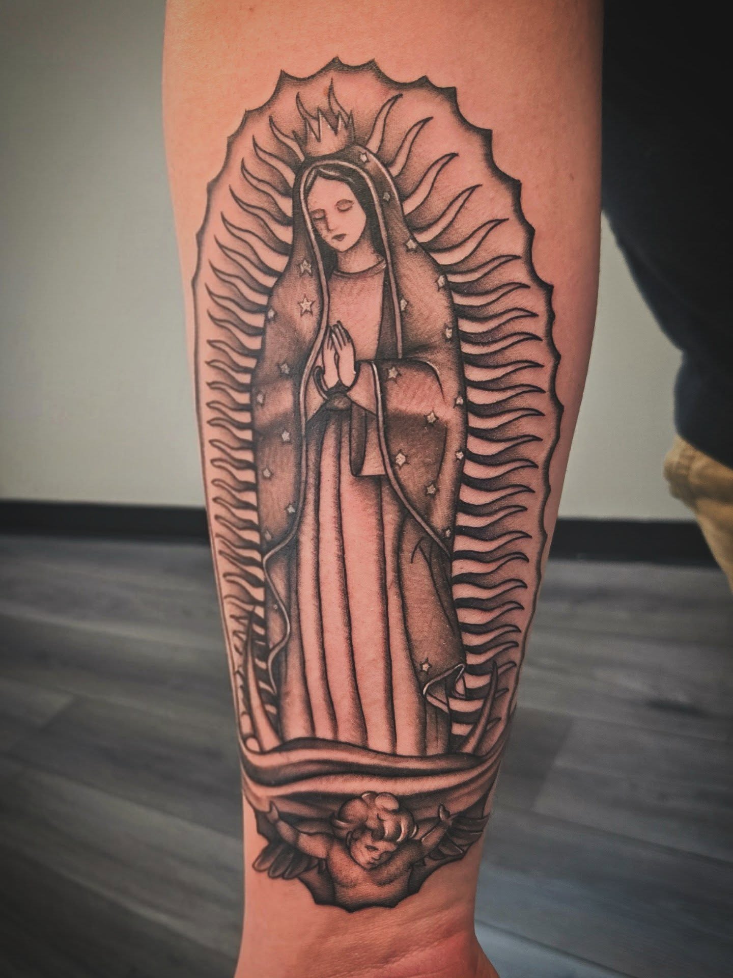 Our Lady of Guadalupe black and grey tattoo on the forearm by Danielle Elizabeth