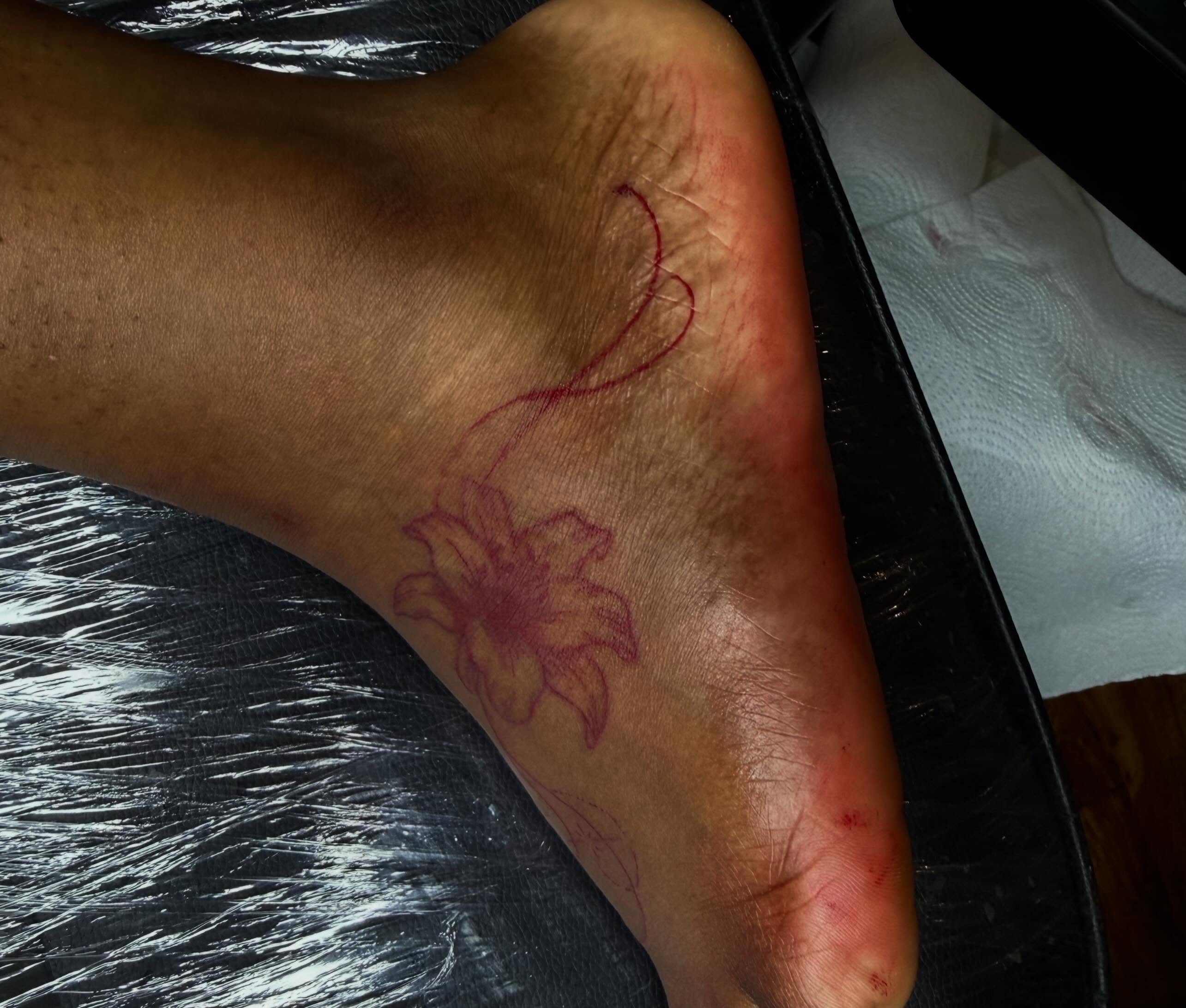 Lily American traditional tattoo on the foot by Tcstatts