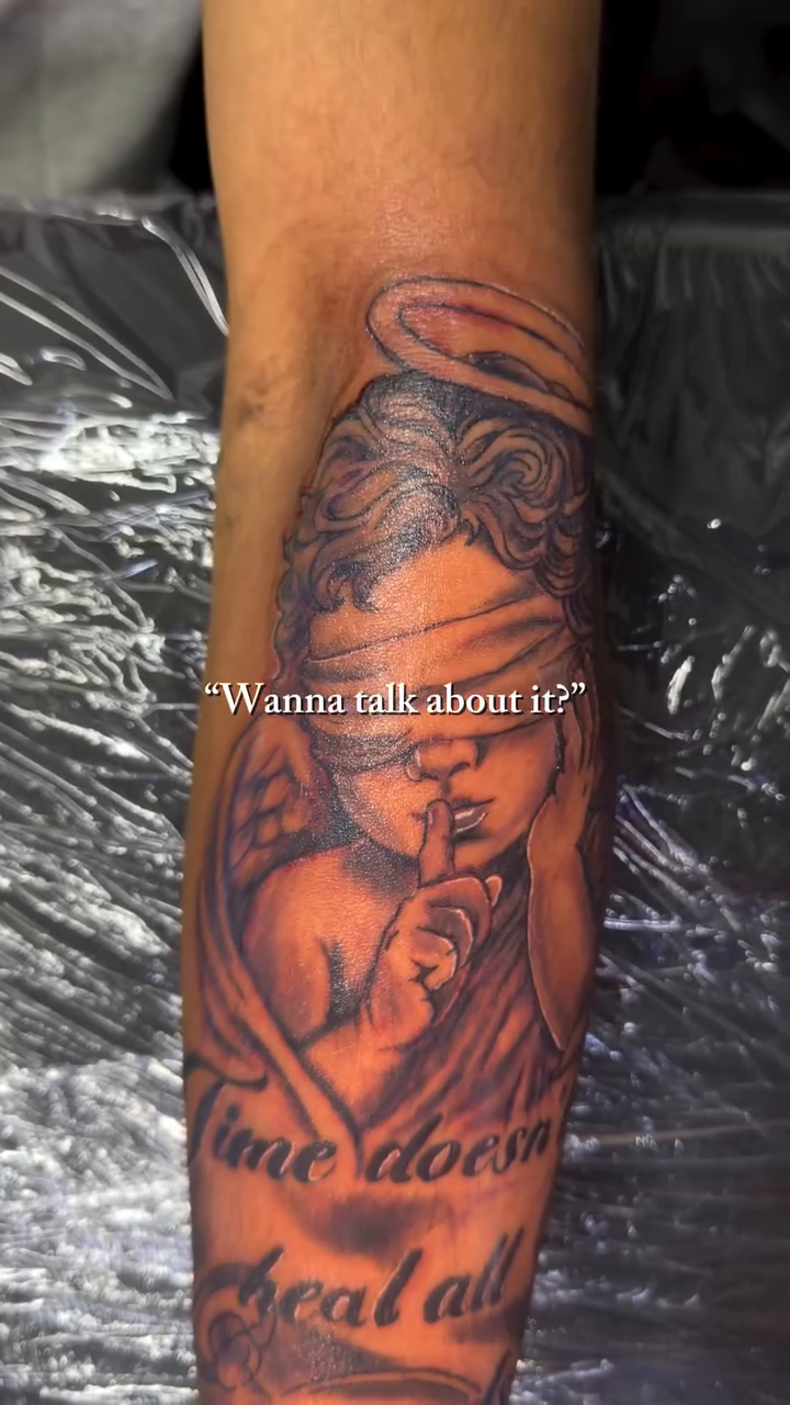 Woman with blindfold and text realism tattoo on the upper arm by 2PaidTattz