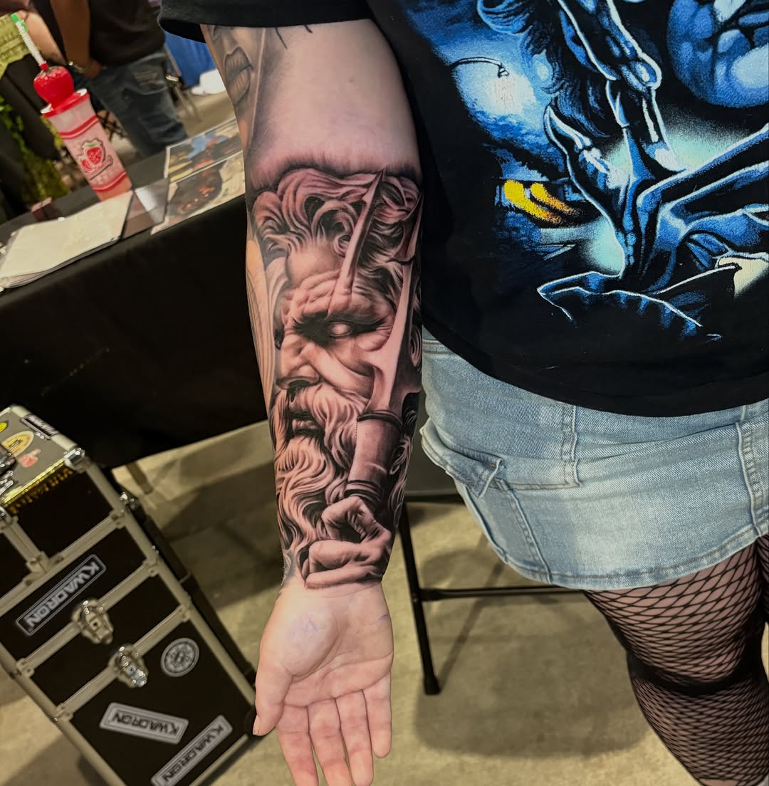 Bust of Poseidon with trident realism tattoo on the forearm by Vonte Seay