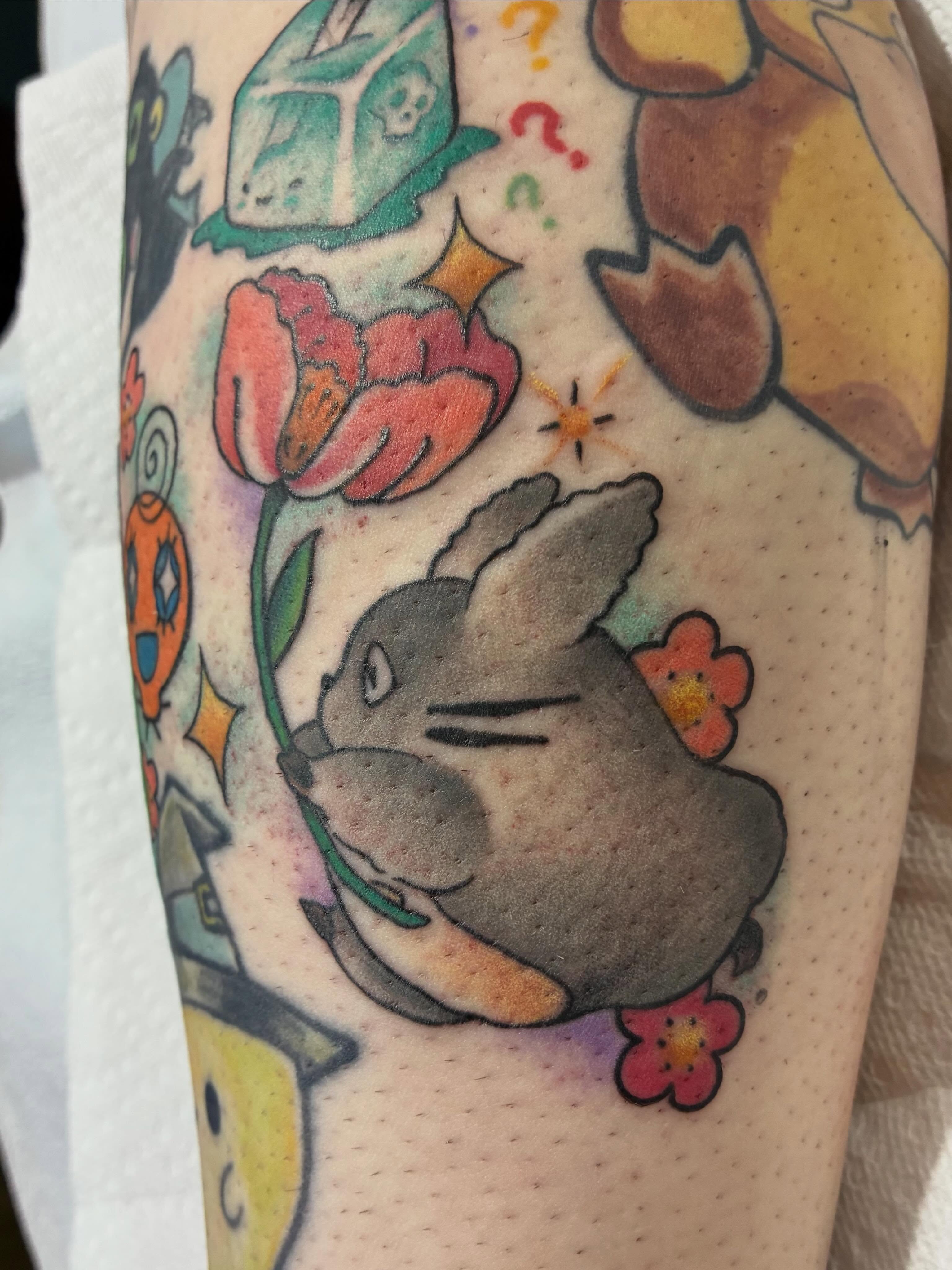 Rabbit with flowers American traditional tattoo on the forearm by Natalie Spuhler