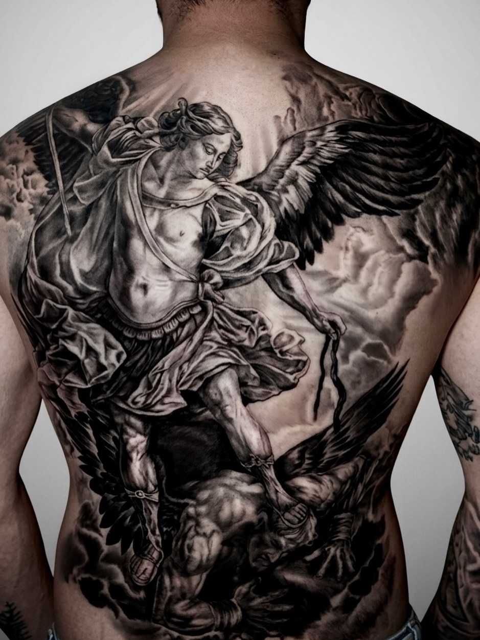 Archangel Michael battling a demon realism tattoo on the back by Alberto Marrero