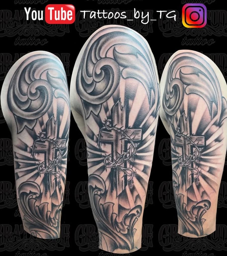 Cross with crown of thorns black and grey tattoo on the forearm by Thomas Gredig