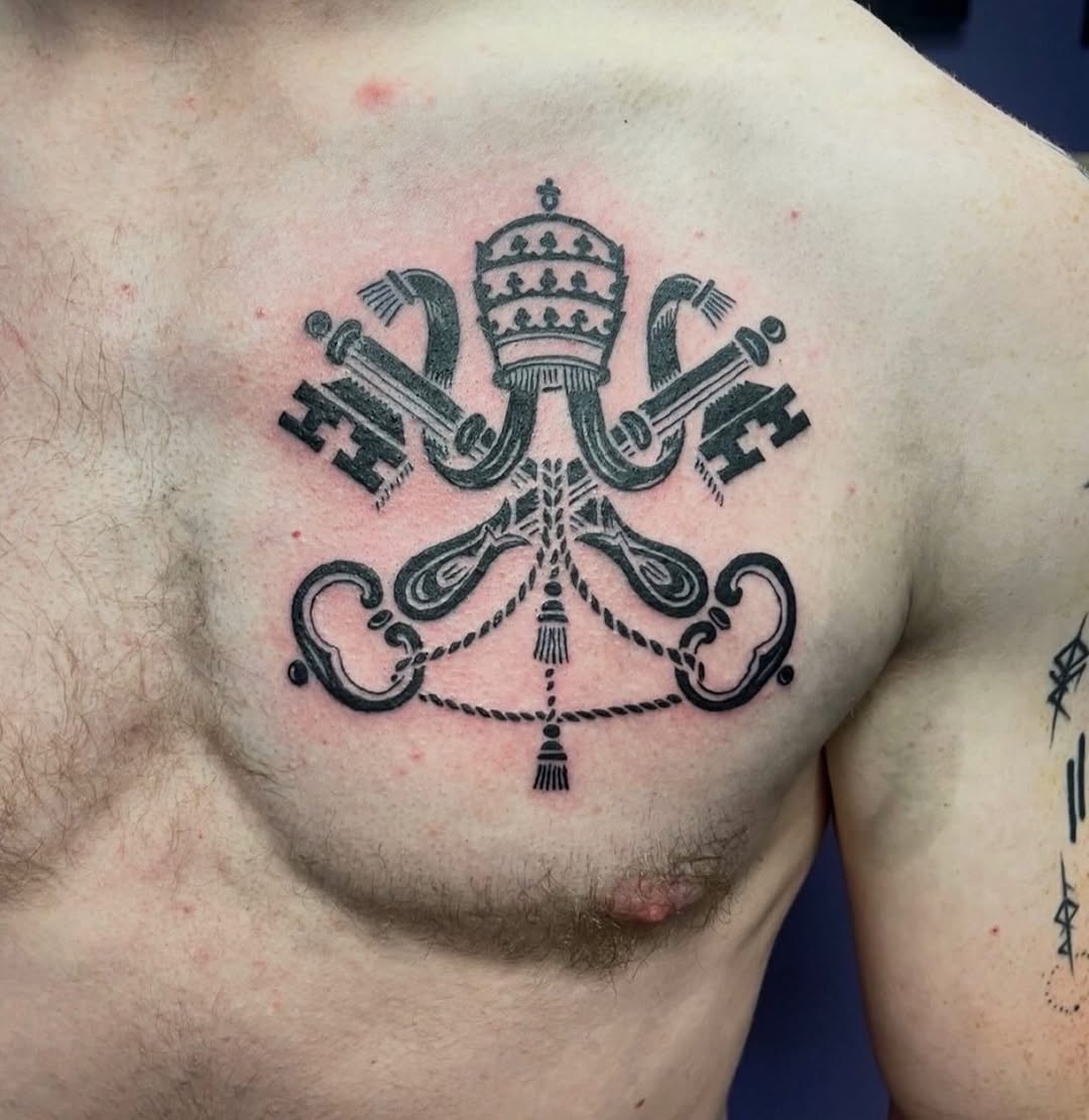 Papal keys and crown emblem dark art tattoo on the chest by Mark Calloway